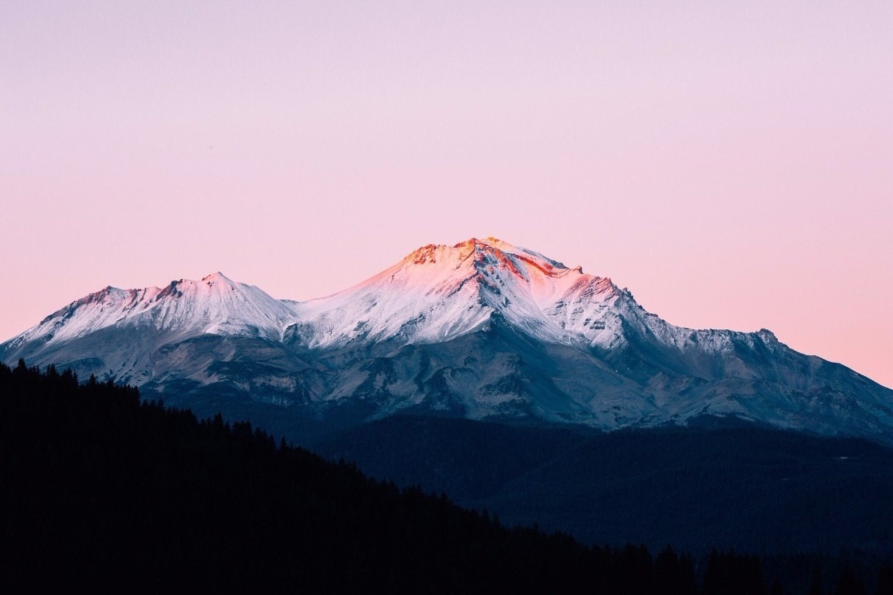 Snow-capped mountains at sunrise with pink sky HD Wallpaper
