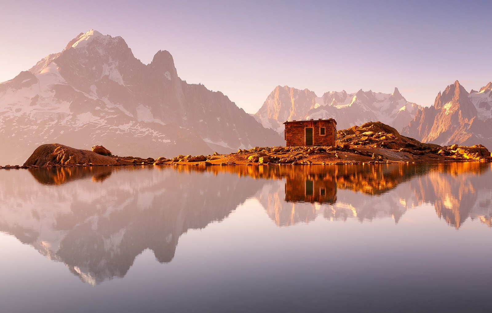 Small house on island with mountain reflection at dawn HD Wallpaper