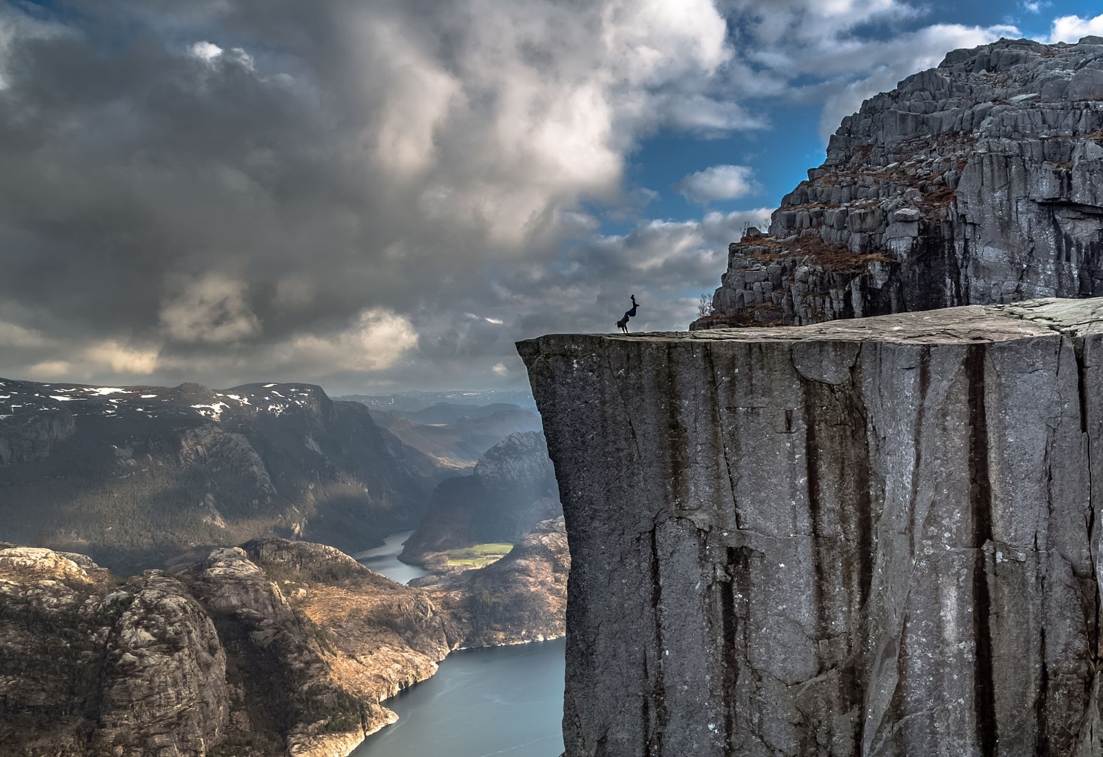 Person doing a handstand on a cliff edge in Norway HD Wallpaper