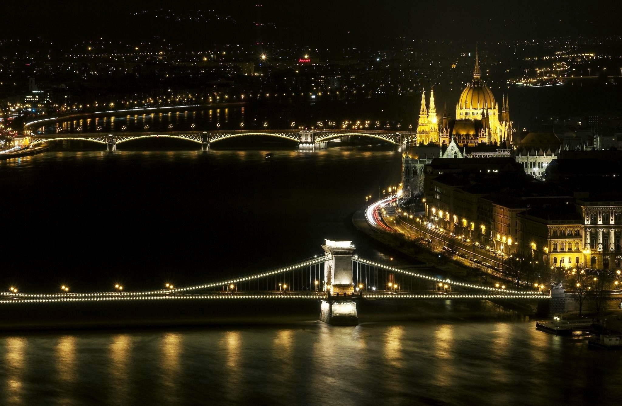 Budapest cityscape at night with illuminated bridges and Parliament Building HD Wallpaper