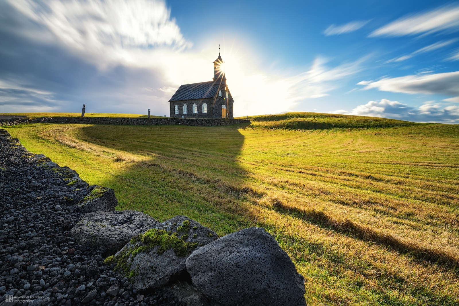 Black church on a grassy hill with sunburst HD Wallpaper