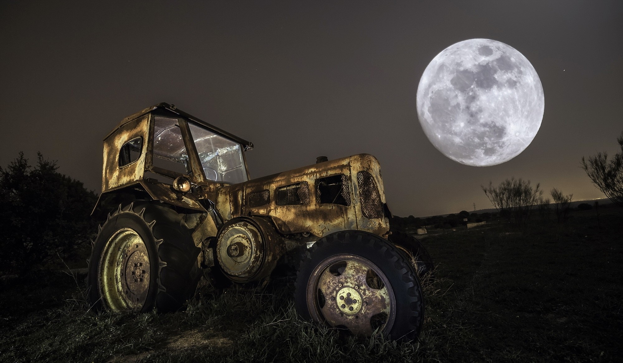 Abandoned tractor under a full moon at night HD Wallpaper