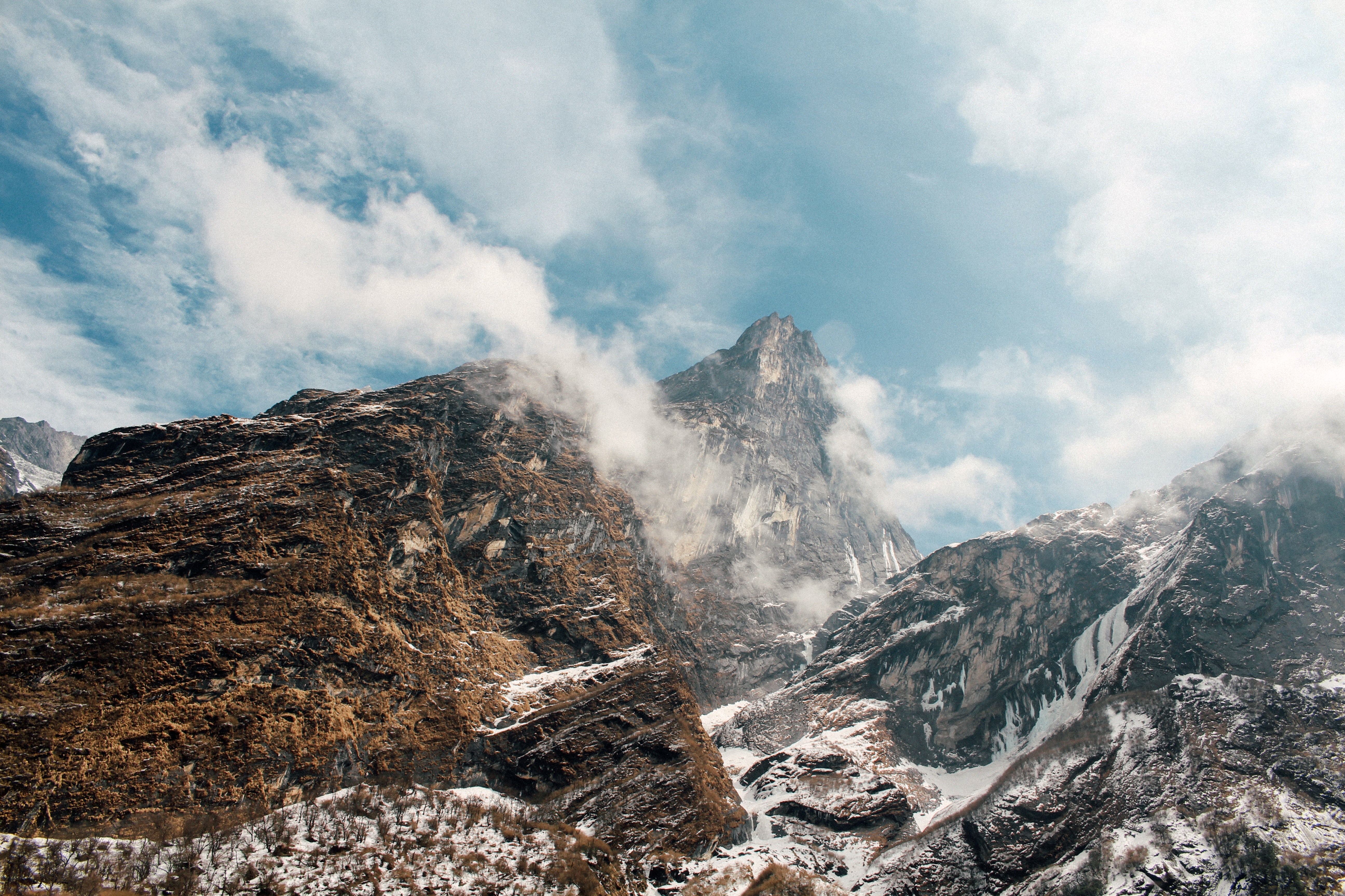 Rocky mountains with snow and clouds HD Wallpaper