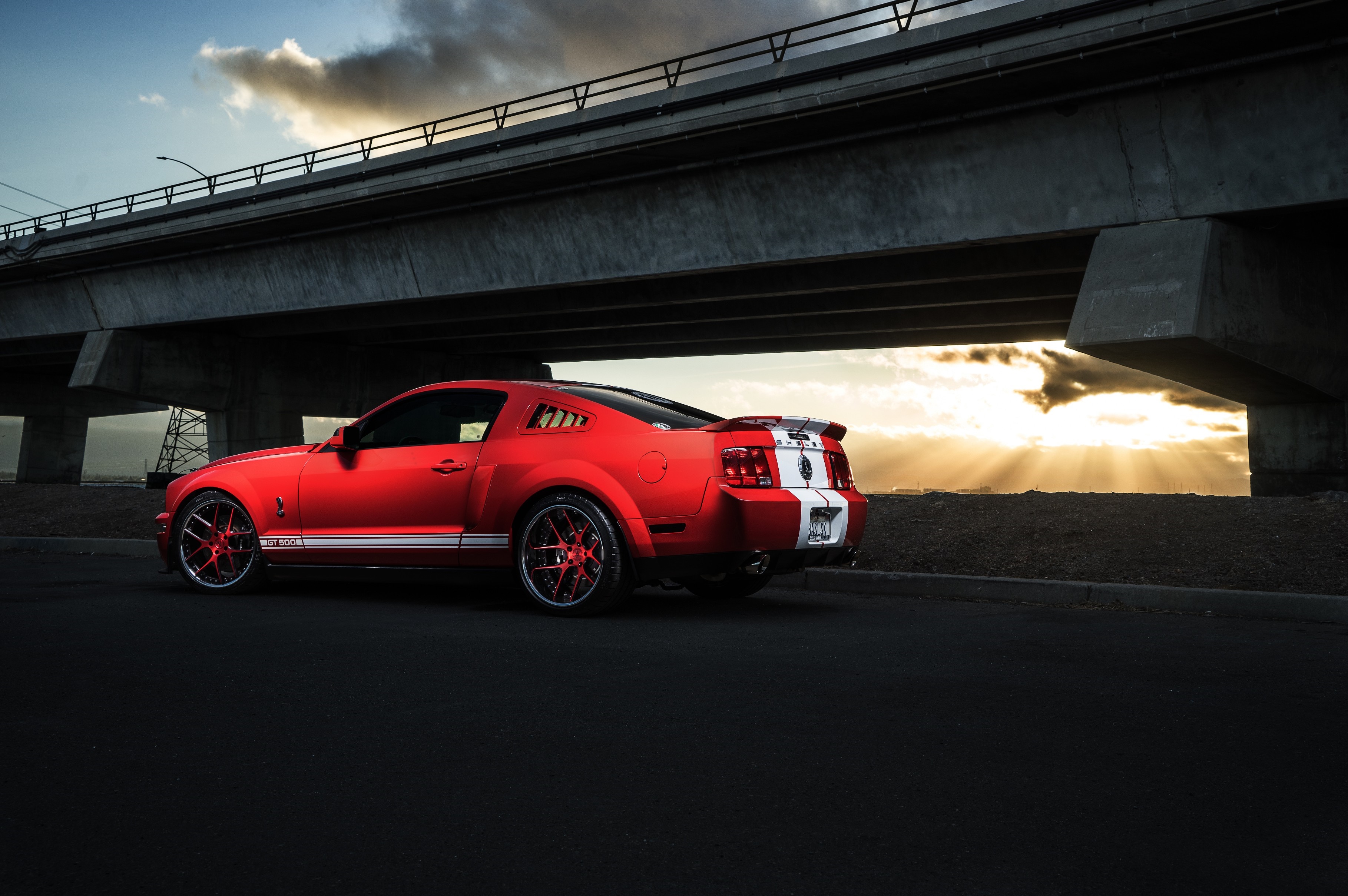 Red Ford Mustang Shelby GT500 parked under a bridge HD Wallpaper