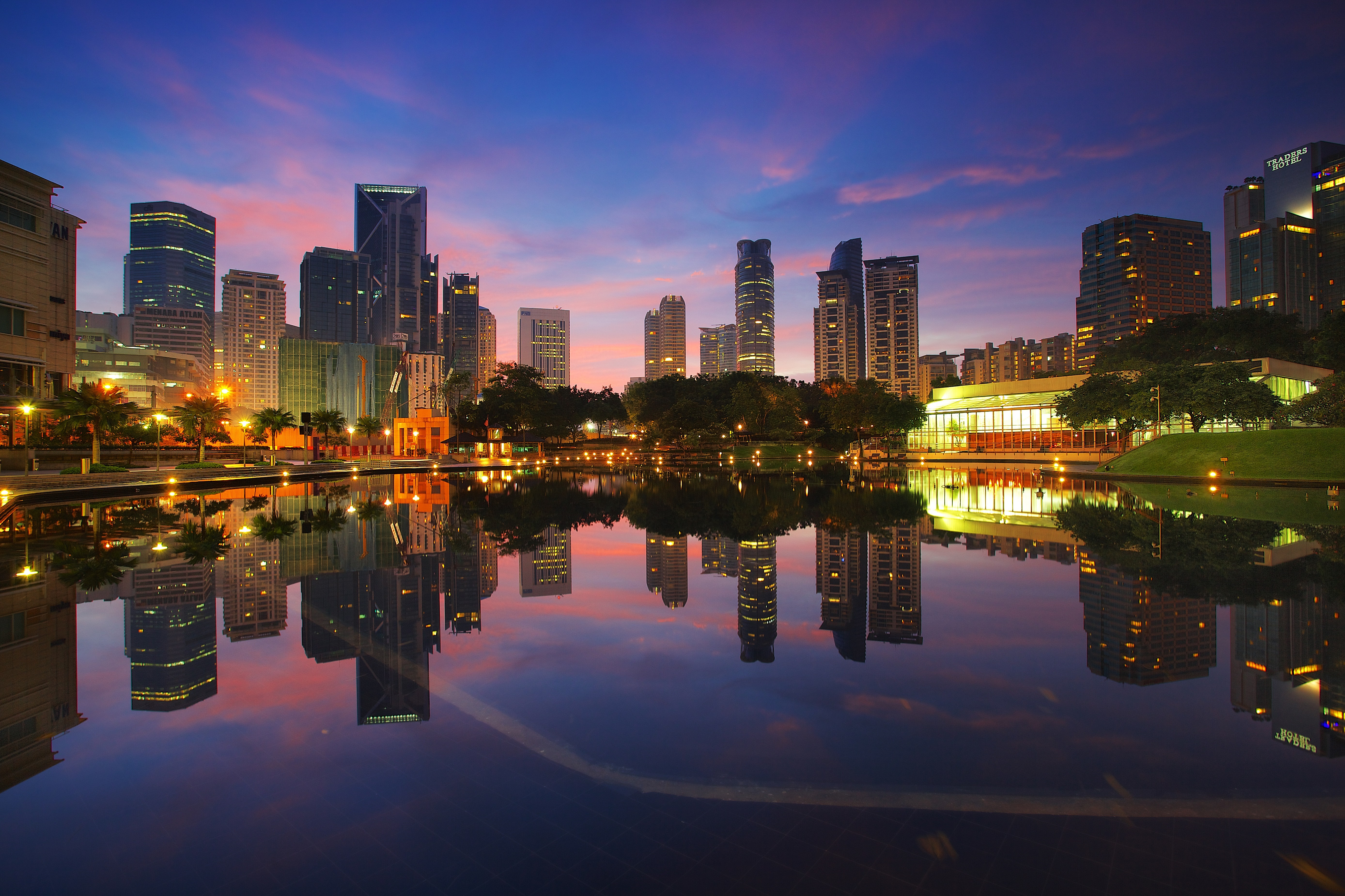 City skyline reflected in water at dusk HD Wallpaper