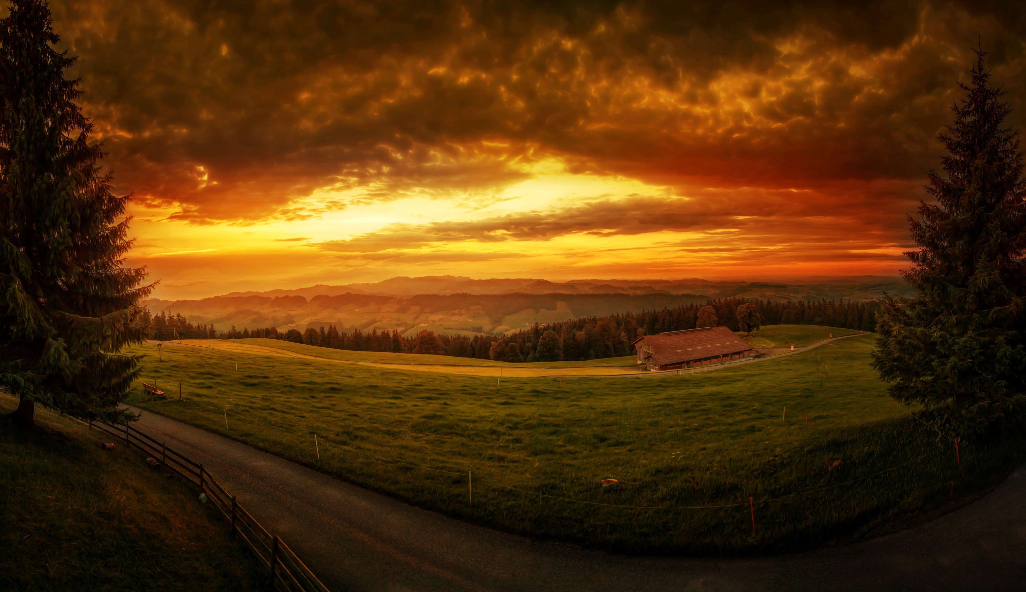 Sunset over rolling hills with a farmhouse HD Wallpaper