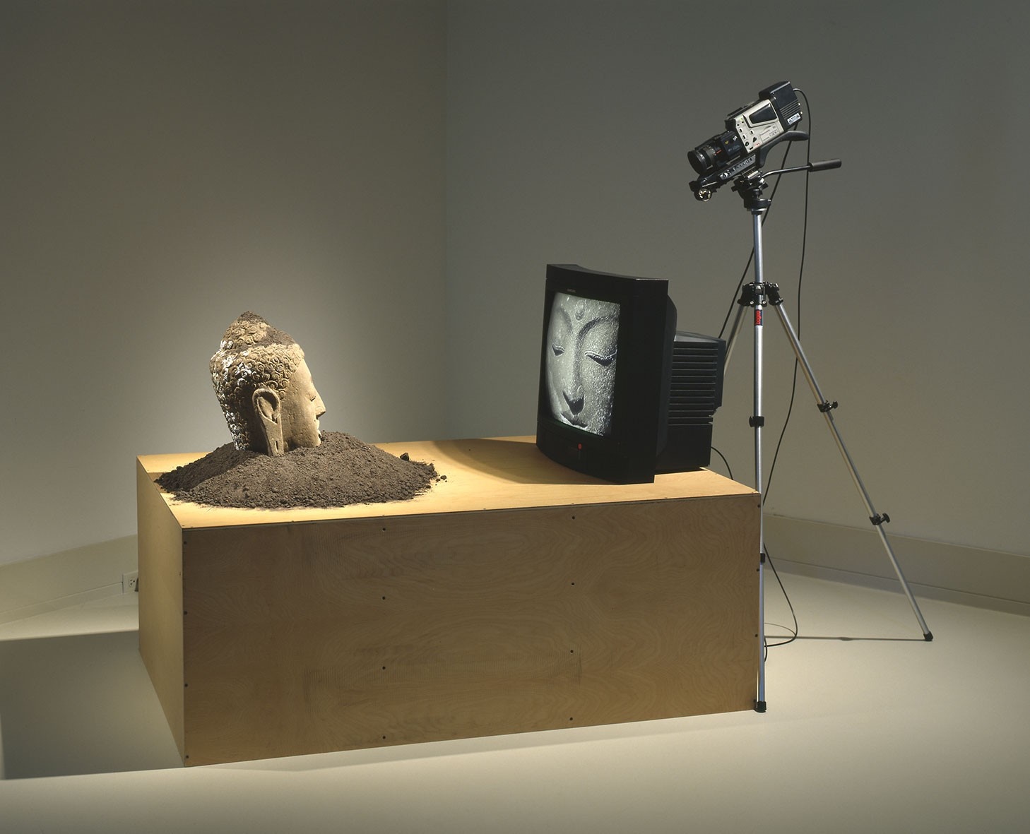 Buddha sculpture on a wooden pedestal with a TV and camera HD Wallpaper