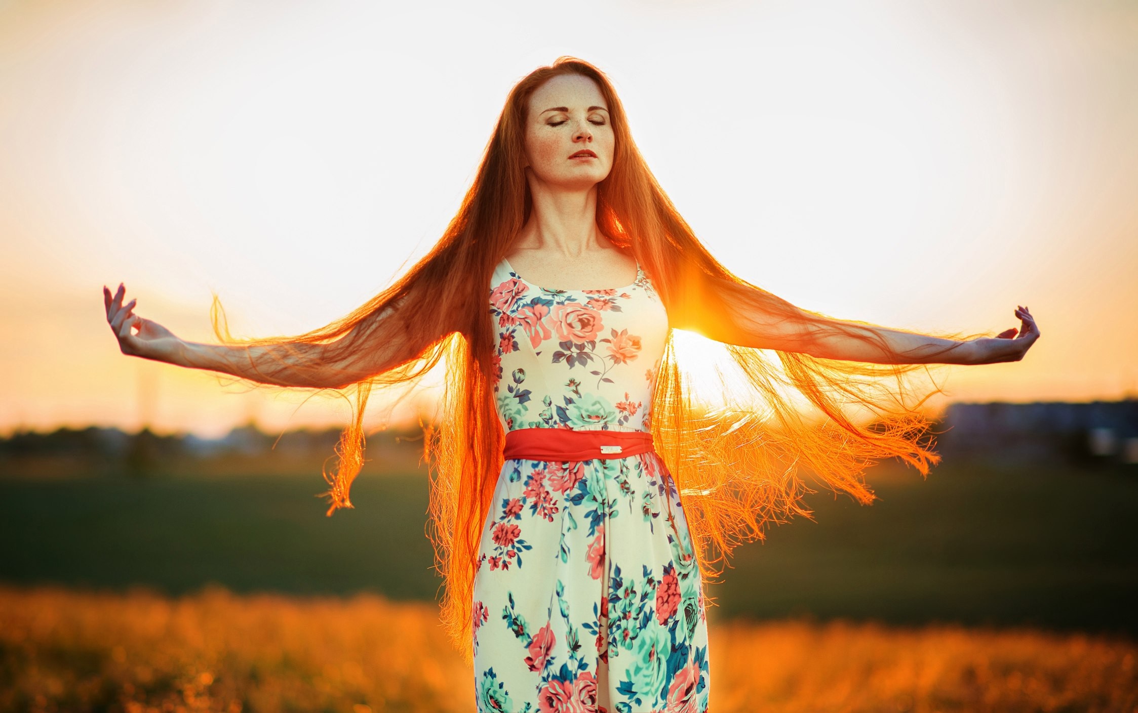 Woman with long red hair in a floral dress at sunset HD Wallpaper