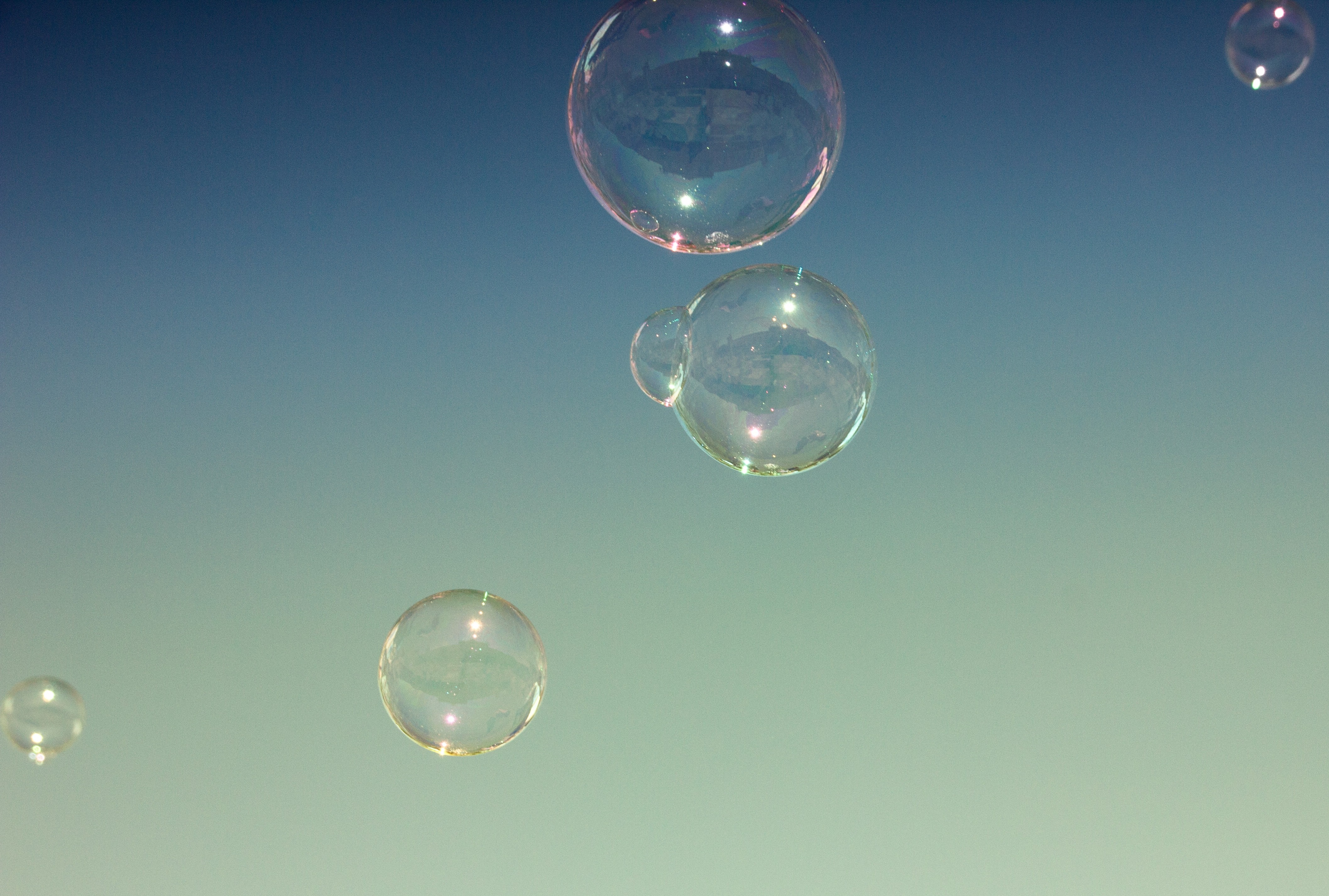 Bubbles floating in a clear blue sky HD Wallpaper
