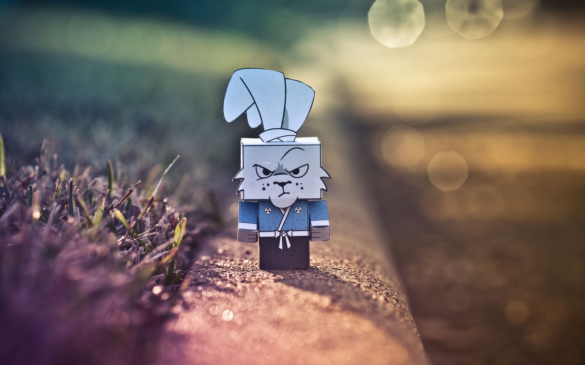 Papercraft rabbit samurai toy on a curb HD Wallpaper