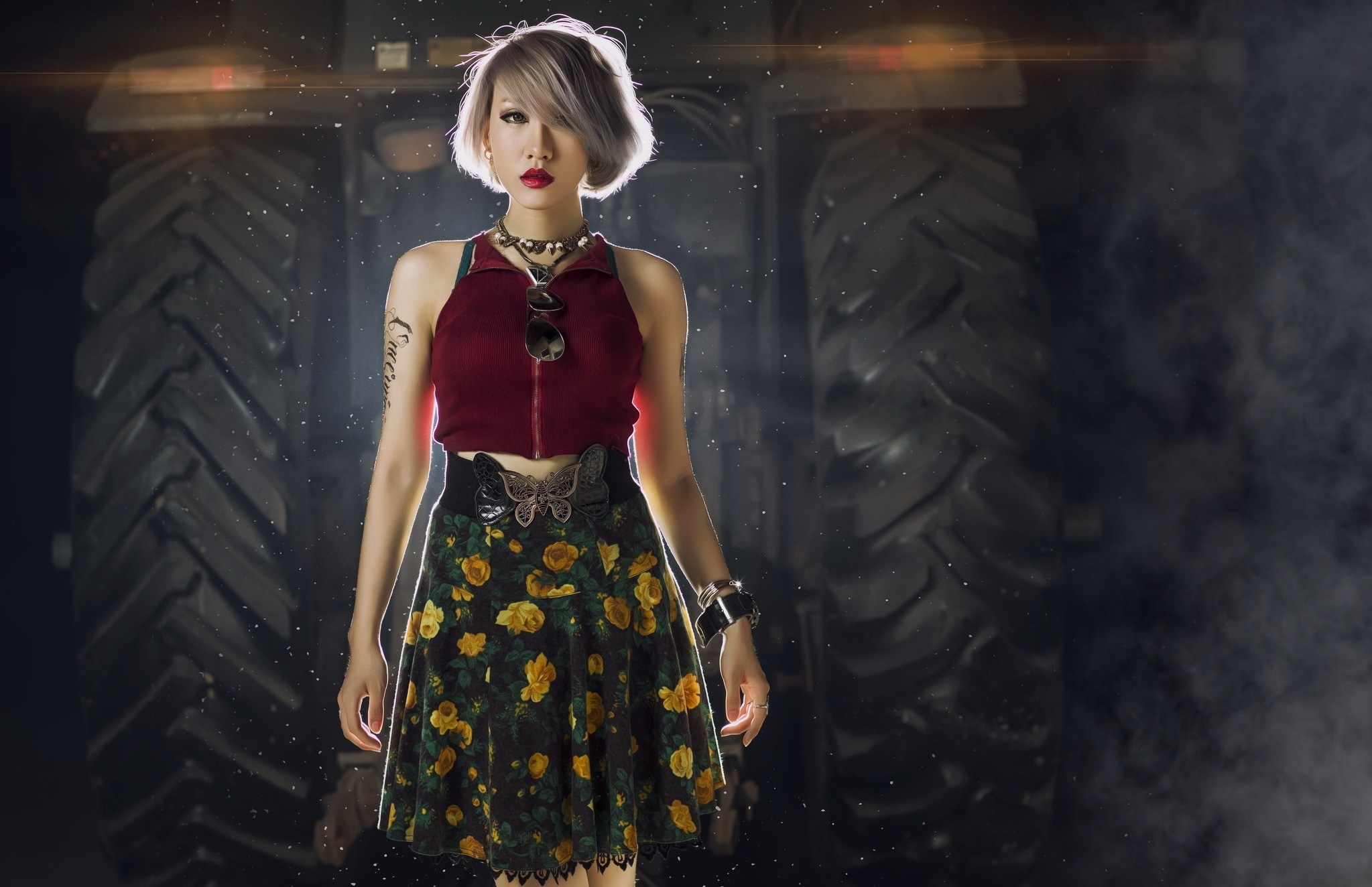 Woman in floral skirt and red top in front of tractor HD Wallpaper