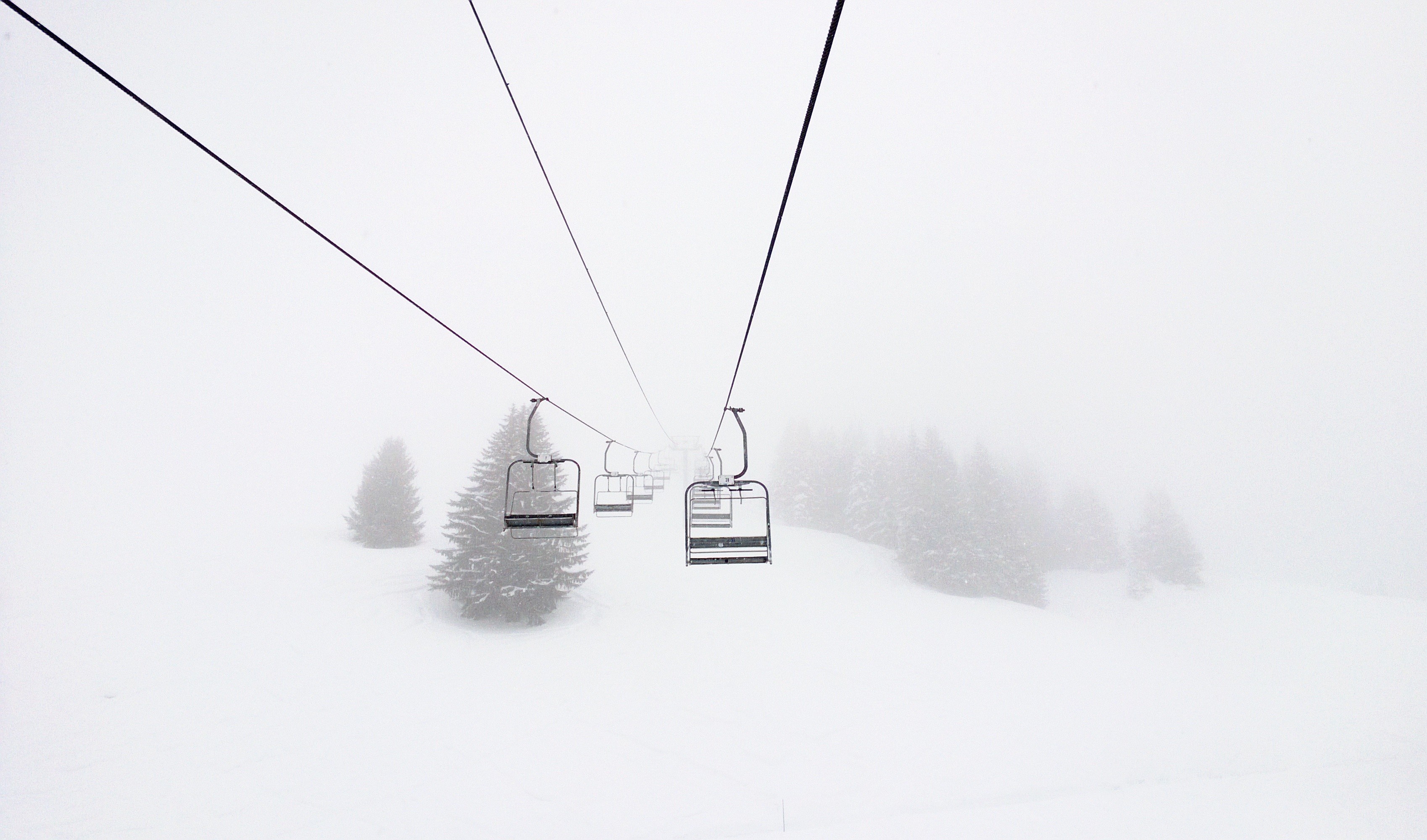 Ski lift in a snowy, misty winter landscape HD Wallpaper