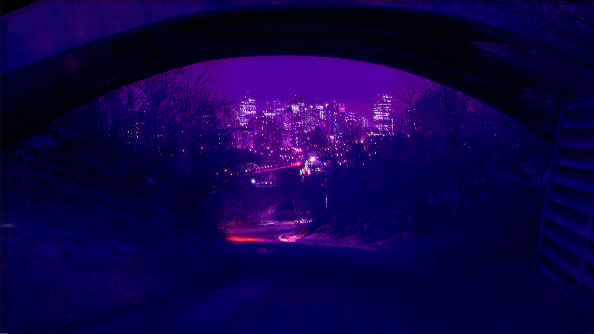 City skyline viewed from under a bridge at night HD Wallpaper