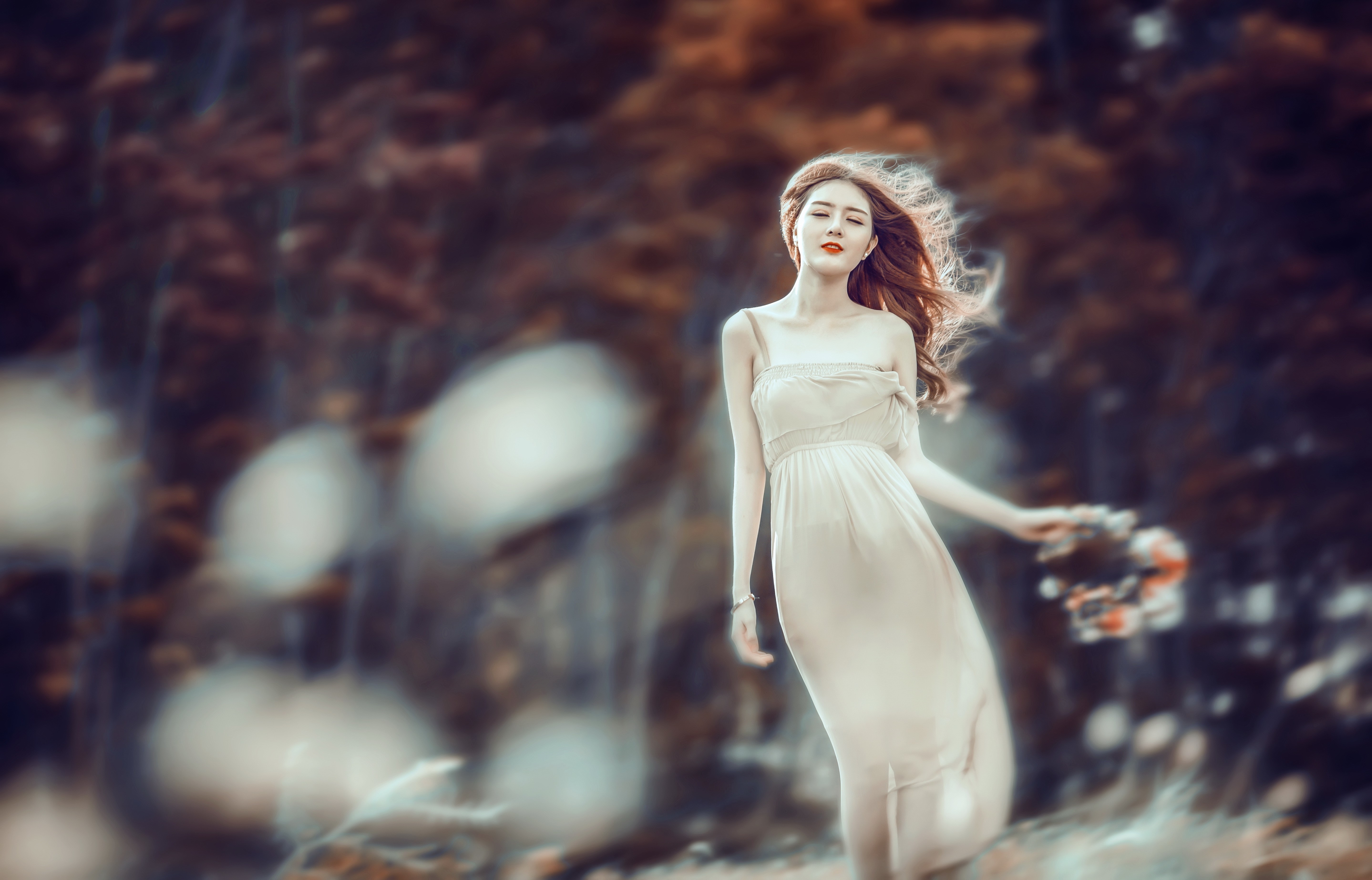 Woman in a light dress holding flowers in a forest HD Wallpaper