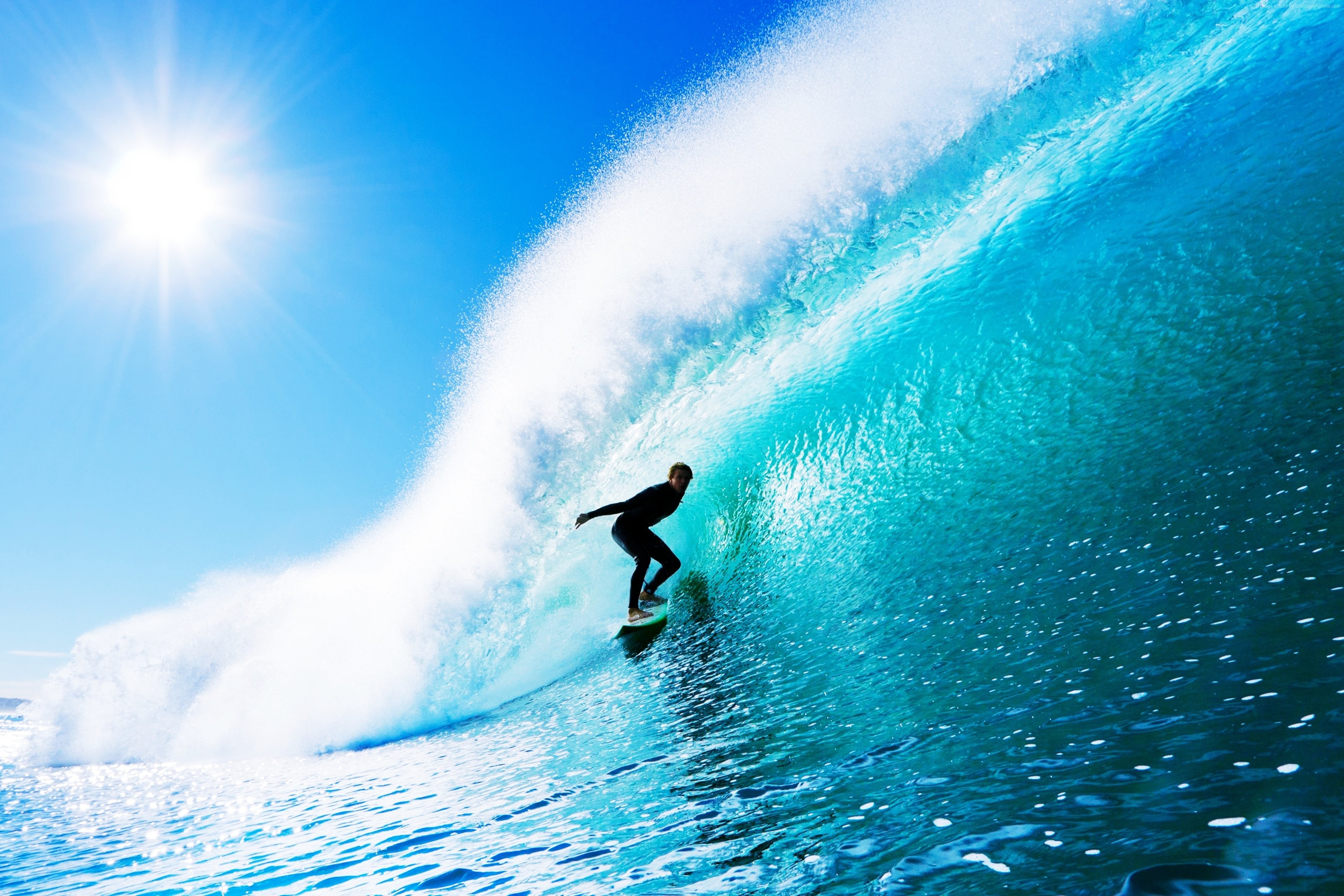 Surfer riding a large wave in the ocean HD Wallpaper