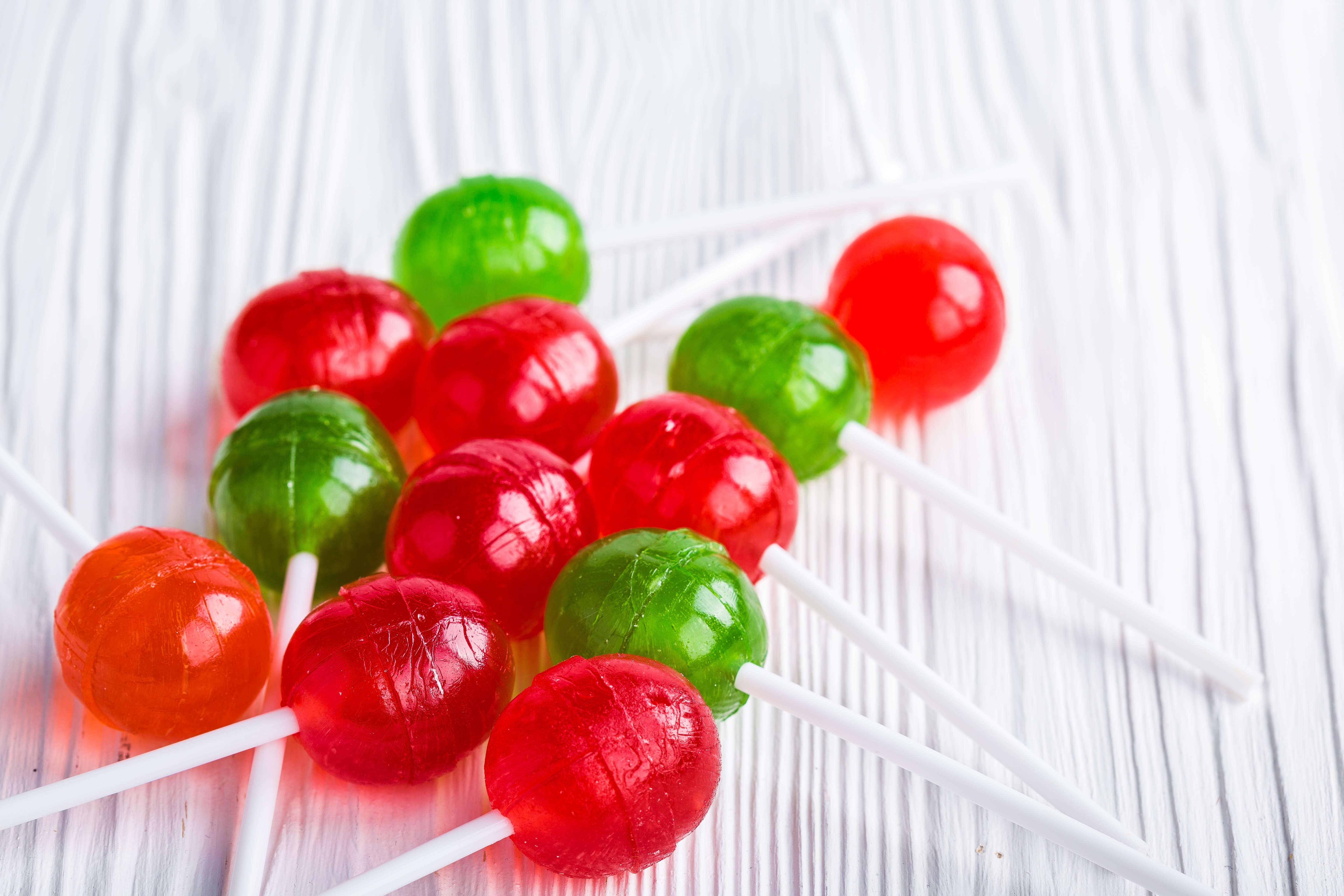 Assorted Lollipops on White Wooden Surface HD Wallpaper