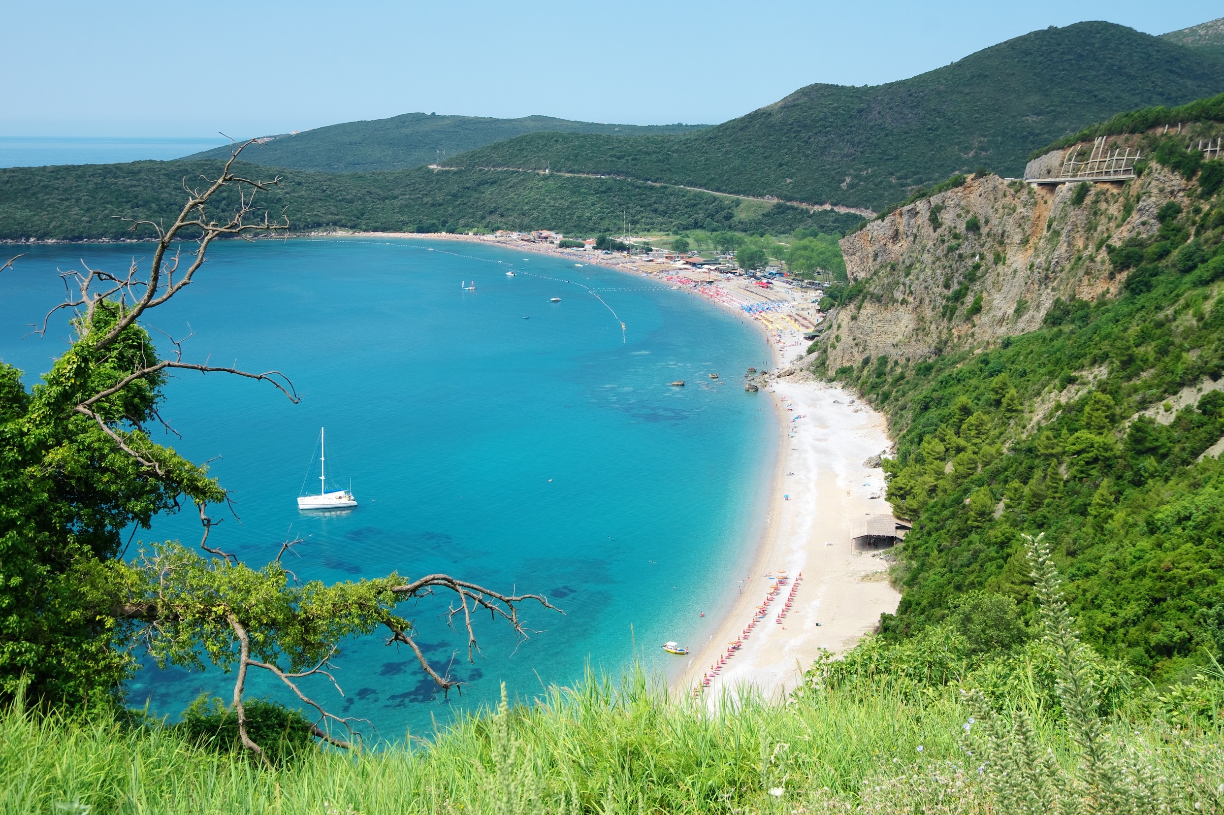 Scenic bay with a sandy beach and green hills HD Wallpaper