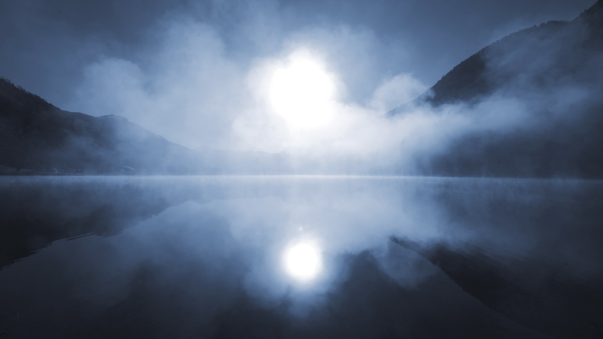 Misty lake with mountains and sun reflection HD Wallpaper
