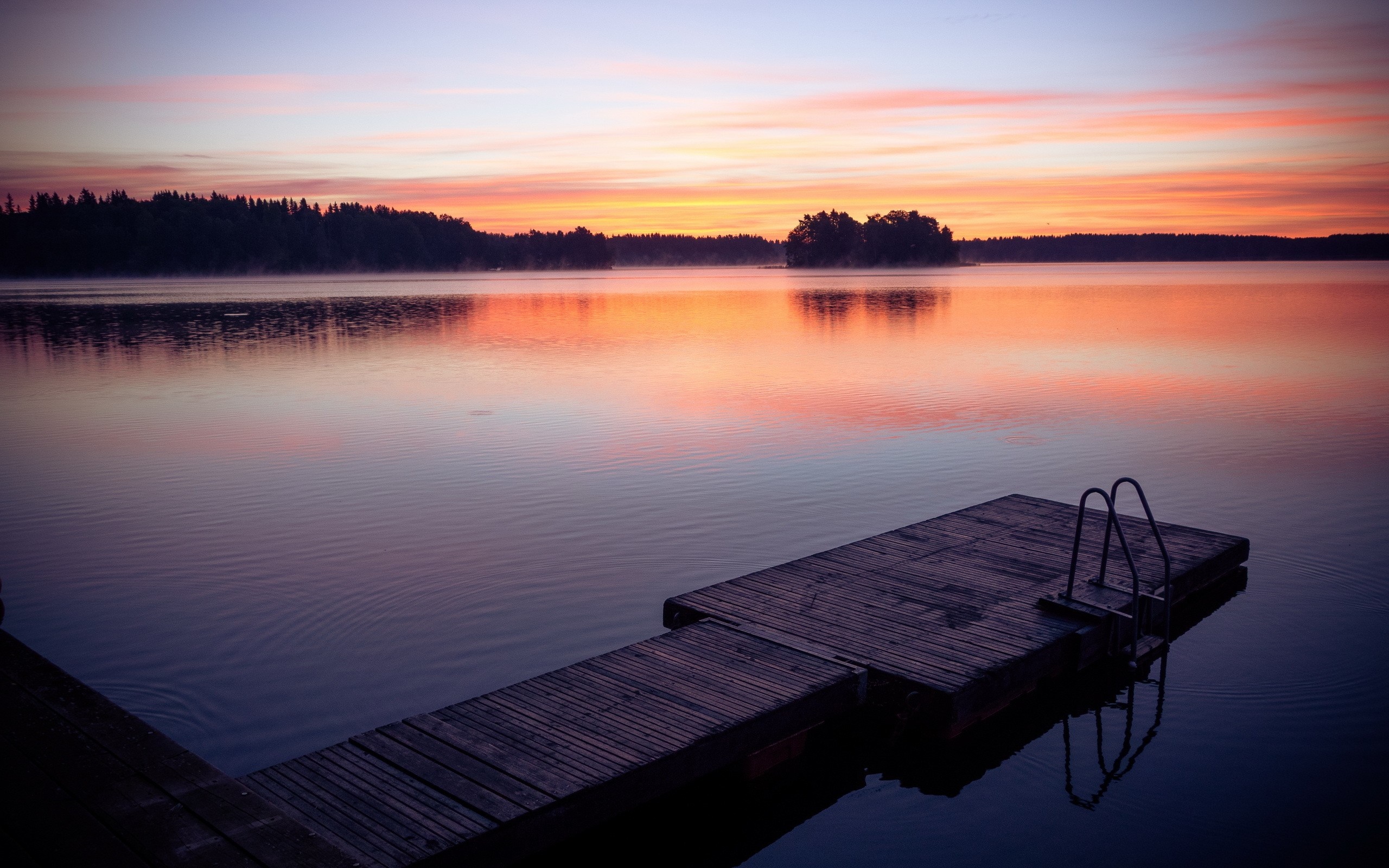Wooden pier on a lake at sunset with colorful sky reflection HD Wallpaper