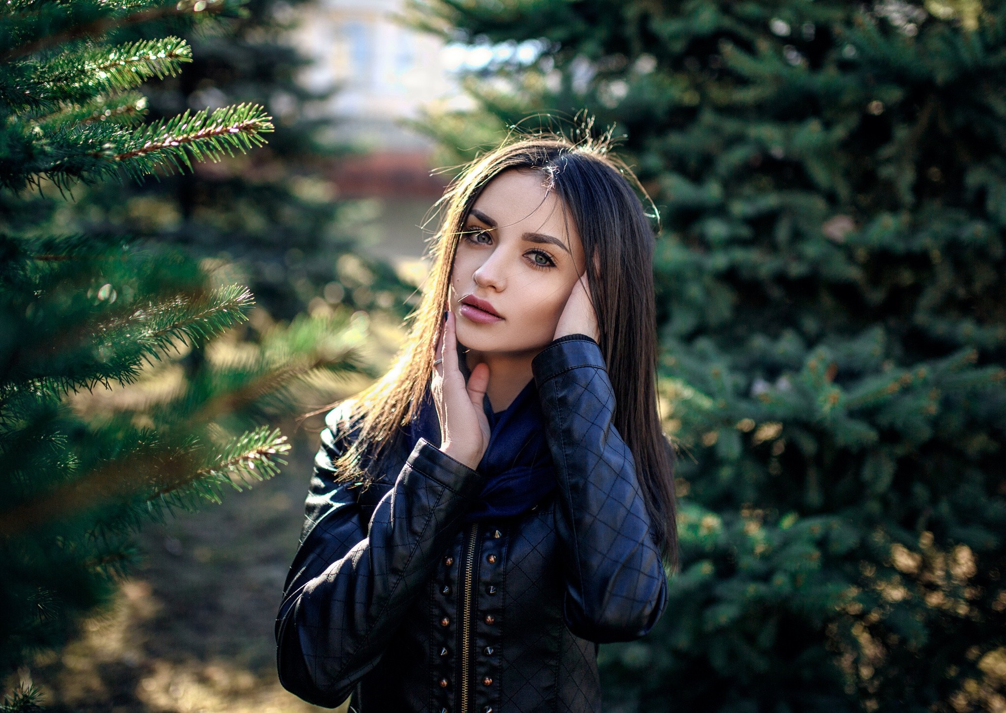Woman with brown hair in a black jacket outdoors HD Wallpaper