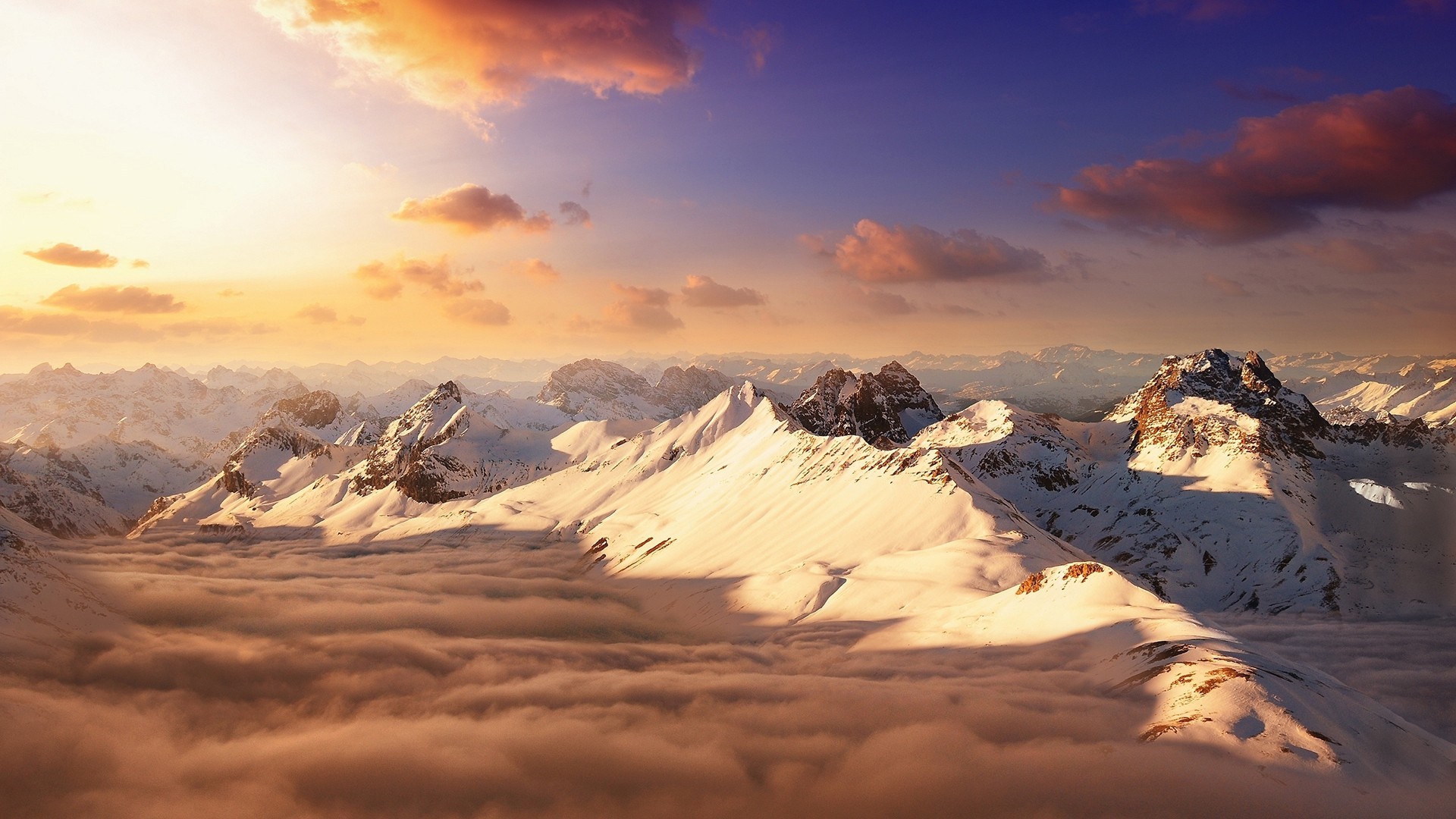 Snow-capped mountains at sunset with clouds HD Wallpaper