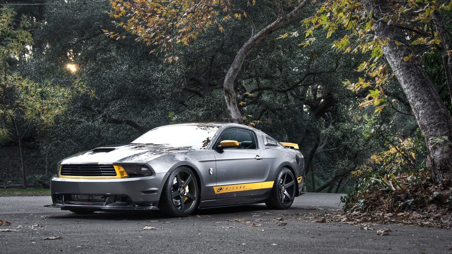 Gray Ford Mustang with yellow accents parked outdoors HD Wallpaper
