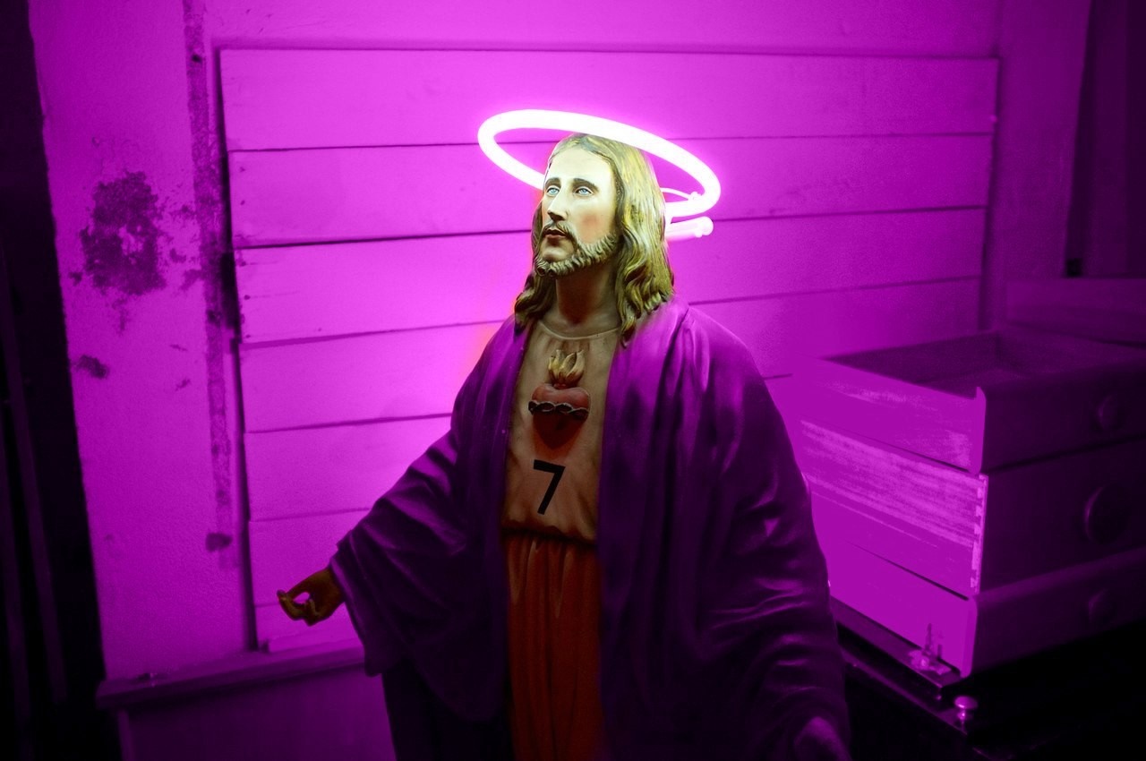 Jesus statue with neon halo and purple robe HD Wallpaper