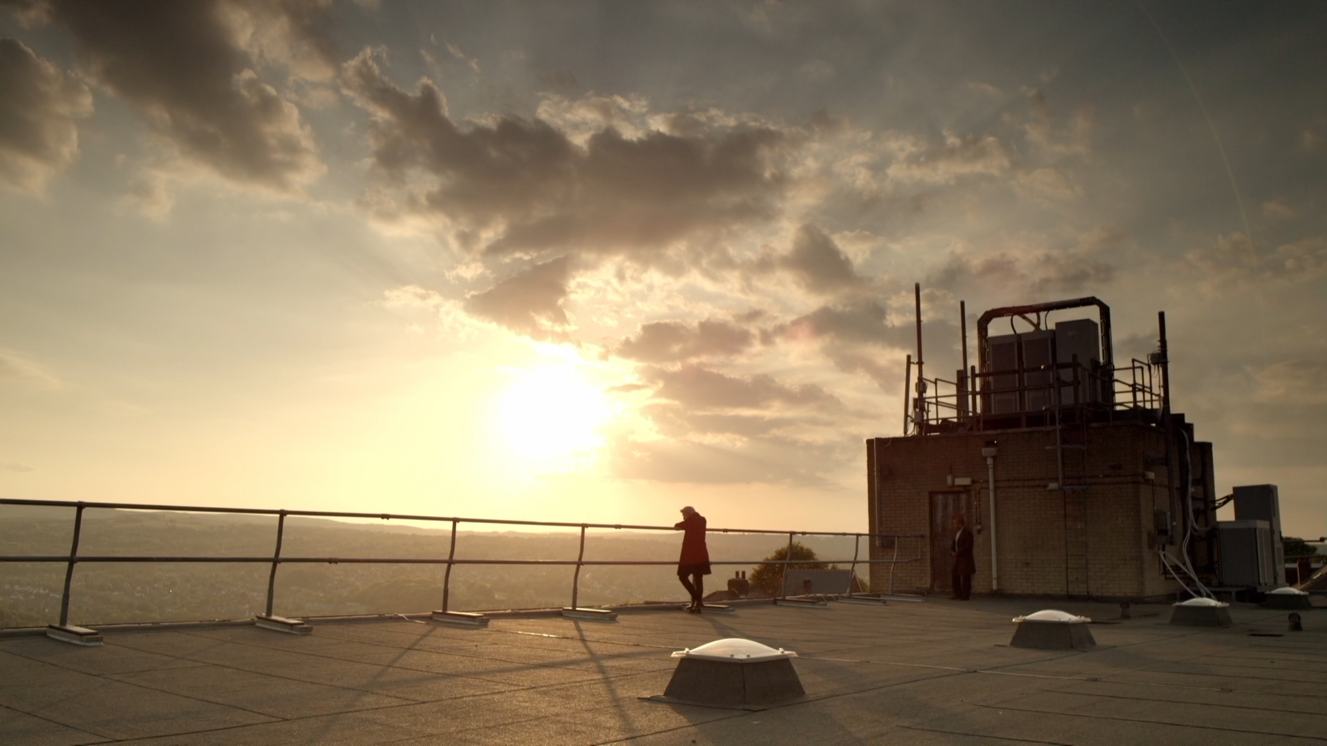 Sunset over a city from a rooftop HD Wallpaper