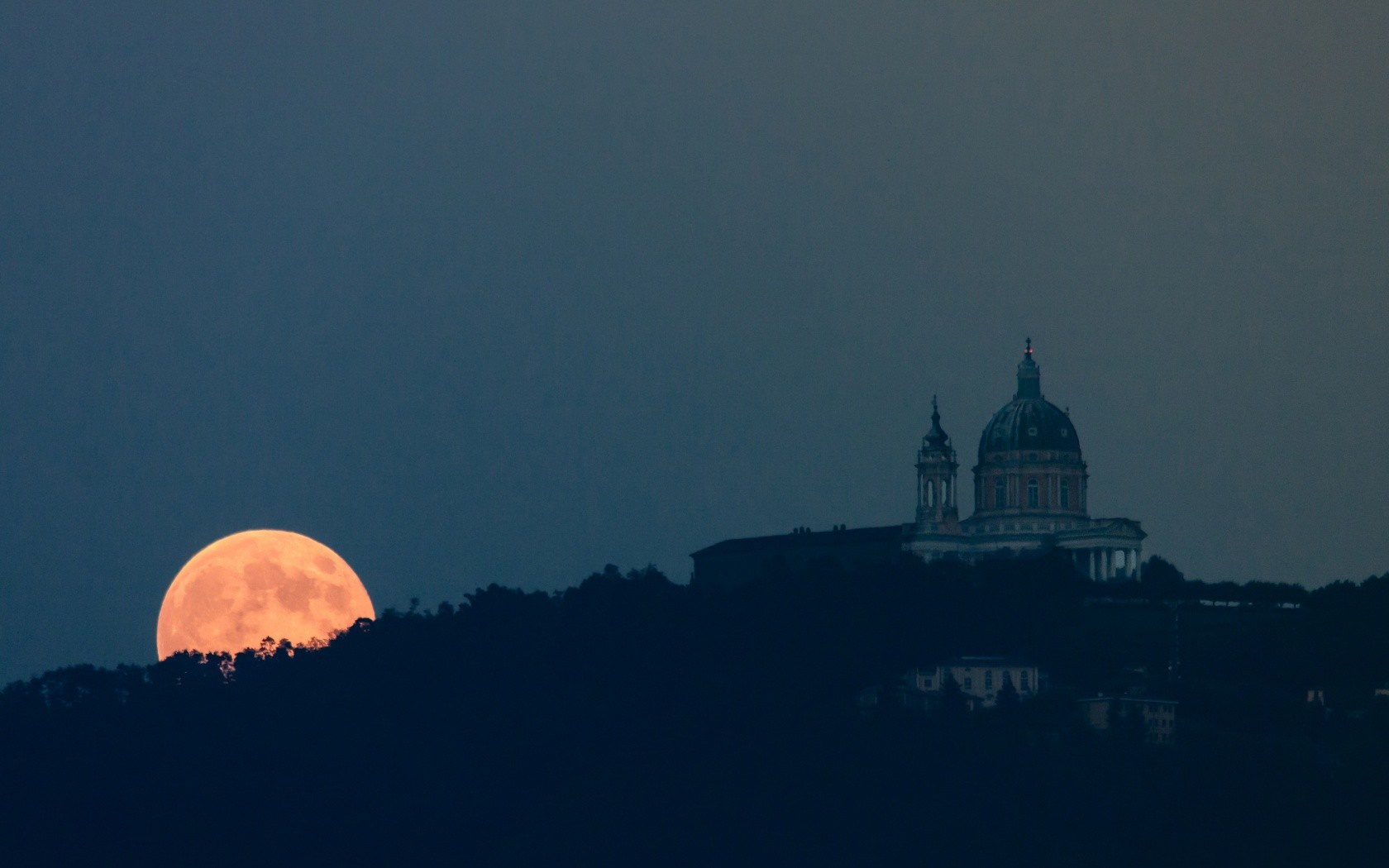 Full moon rising over a hill with a building HD Wallpaper