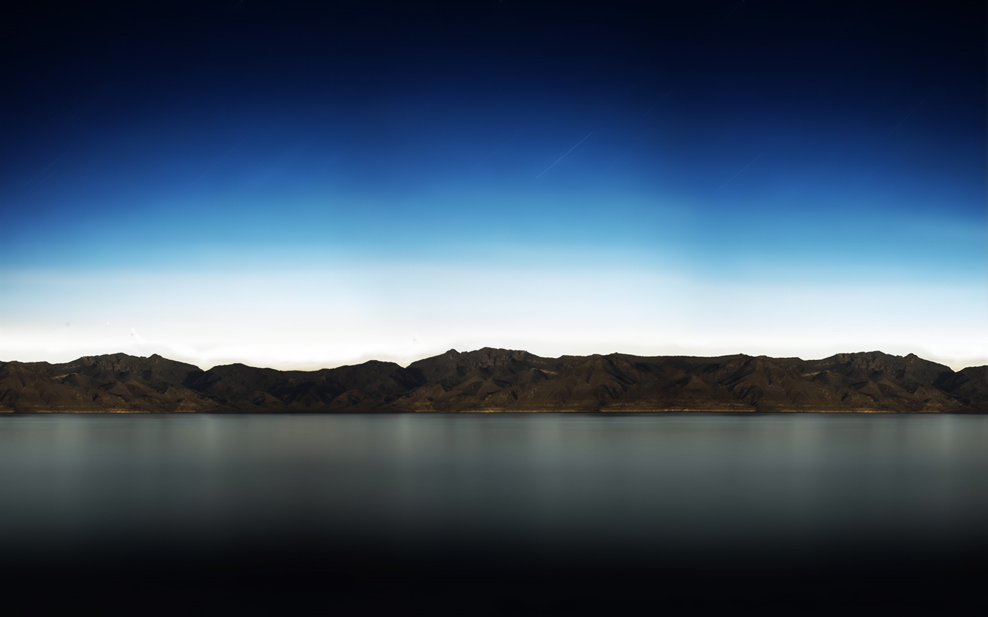 Mountain range reflected in a lake at dusk HD Wallpaper