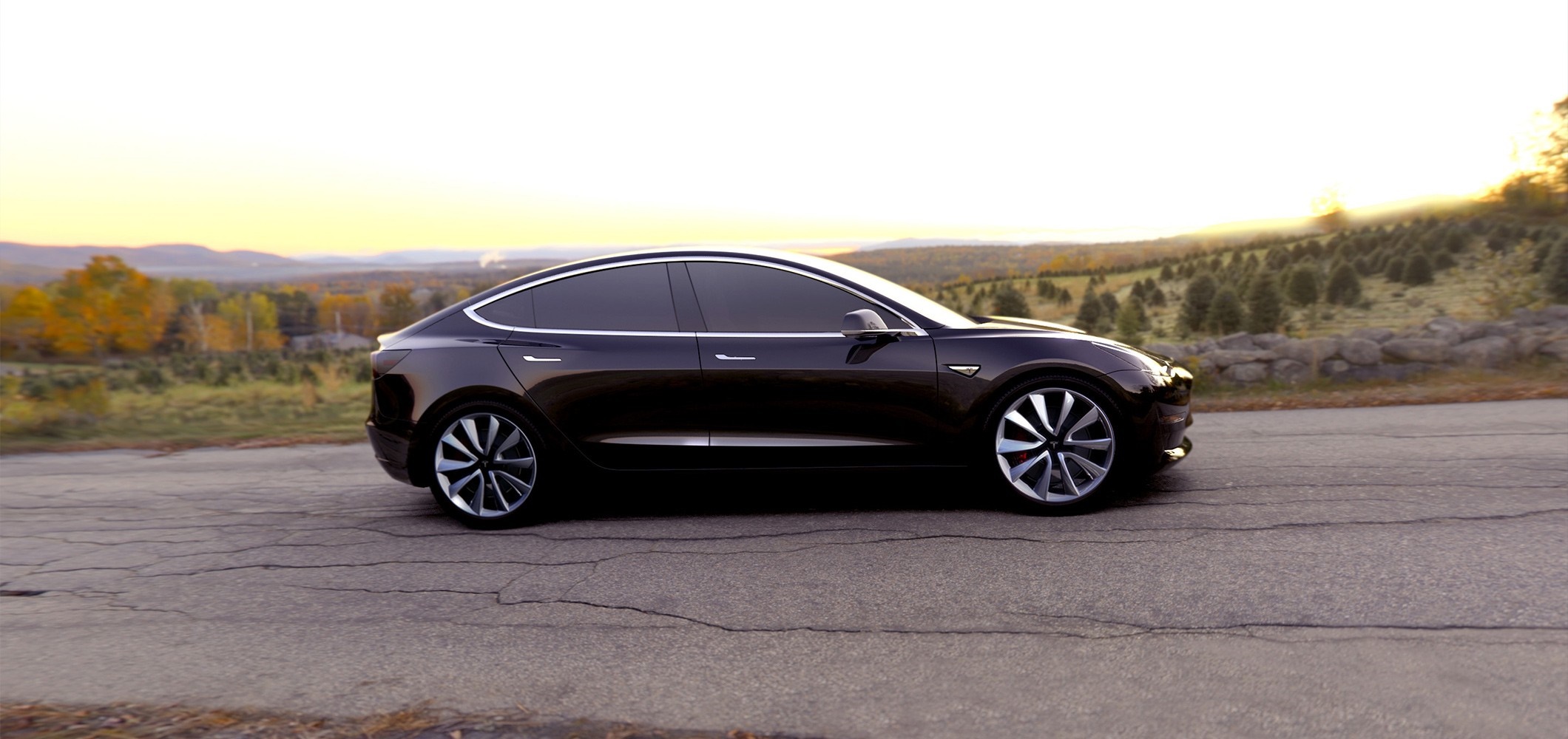 Dark Tesla Model 3 Sedan on a Road HD Wallpaper