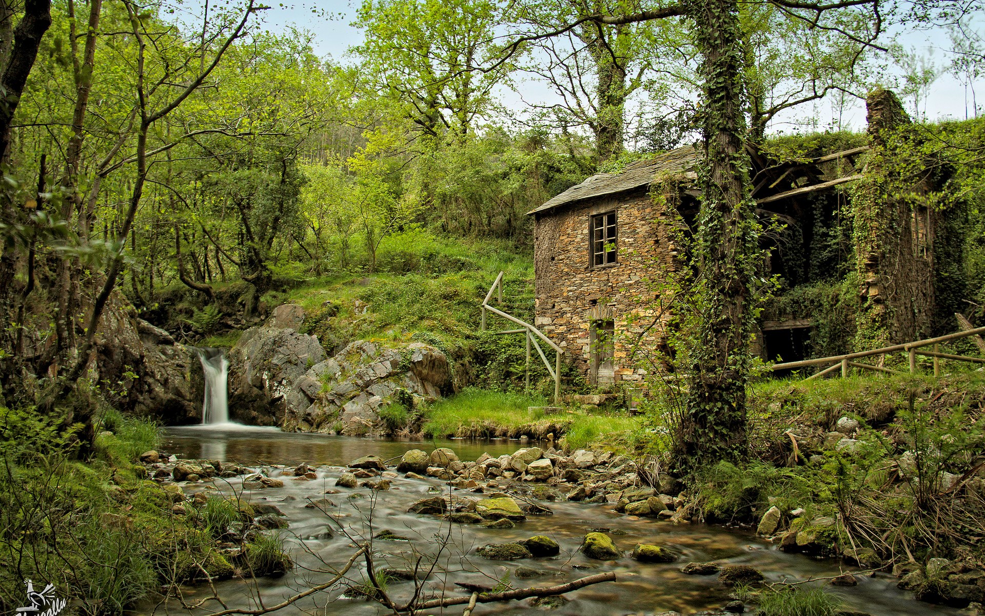 Abandoned stone mill by a waterfall in a forest HD Wallpaper