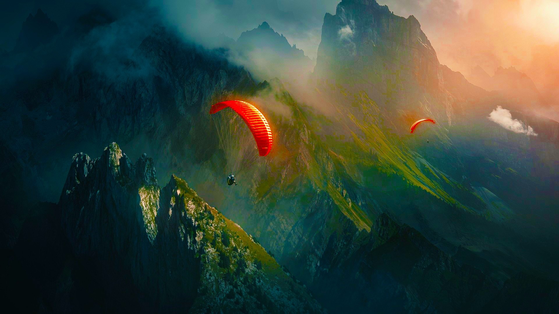 Paragliders soaring over misty mountains at sunset HD Wallpaper