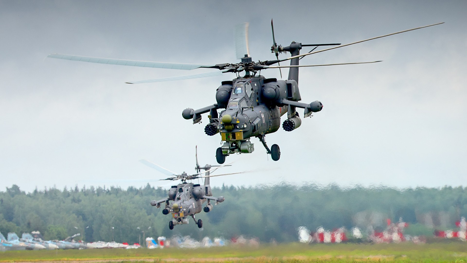 Two Mil Mi-28 attack helicopters in flight HD Wallpaper