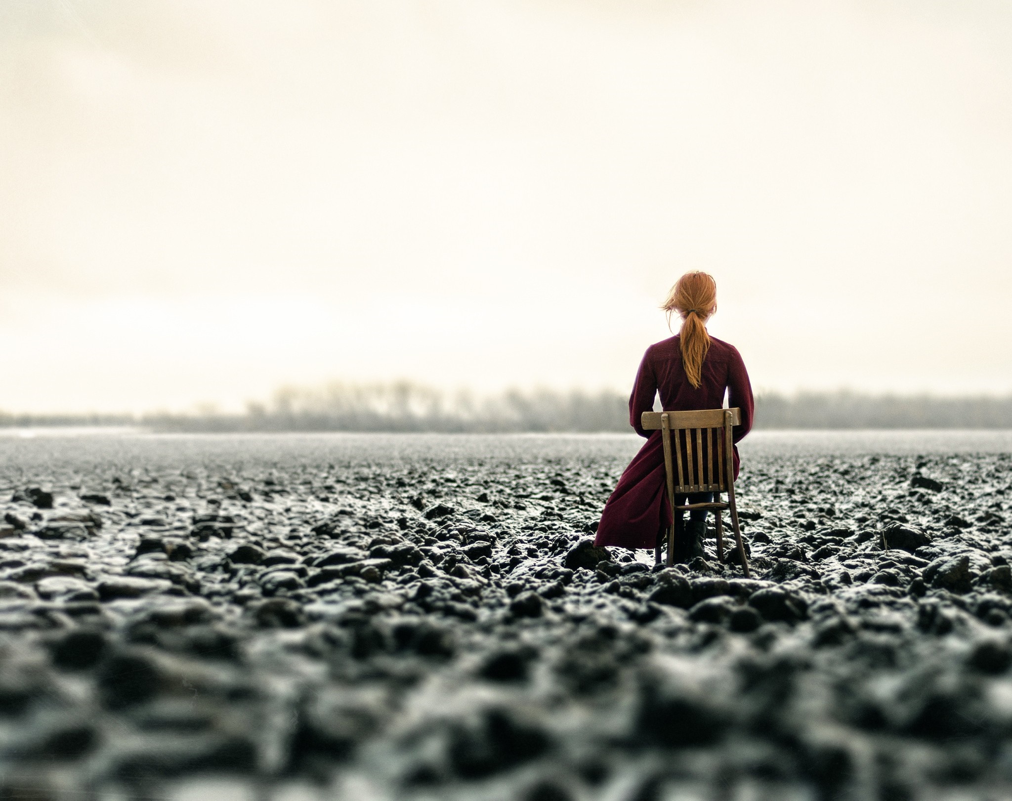 Woman sitting on a chair in a field HD Wallpaper