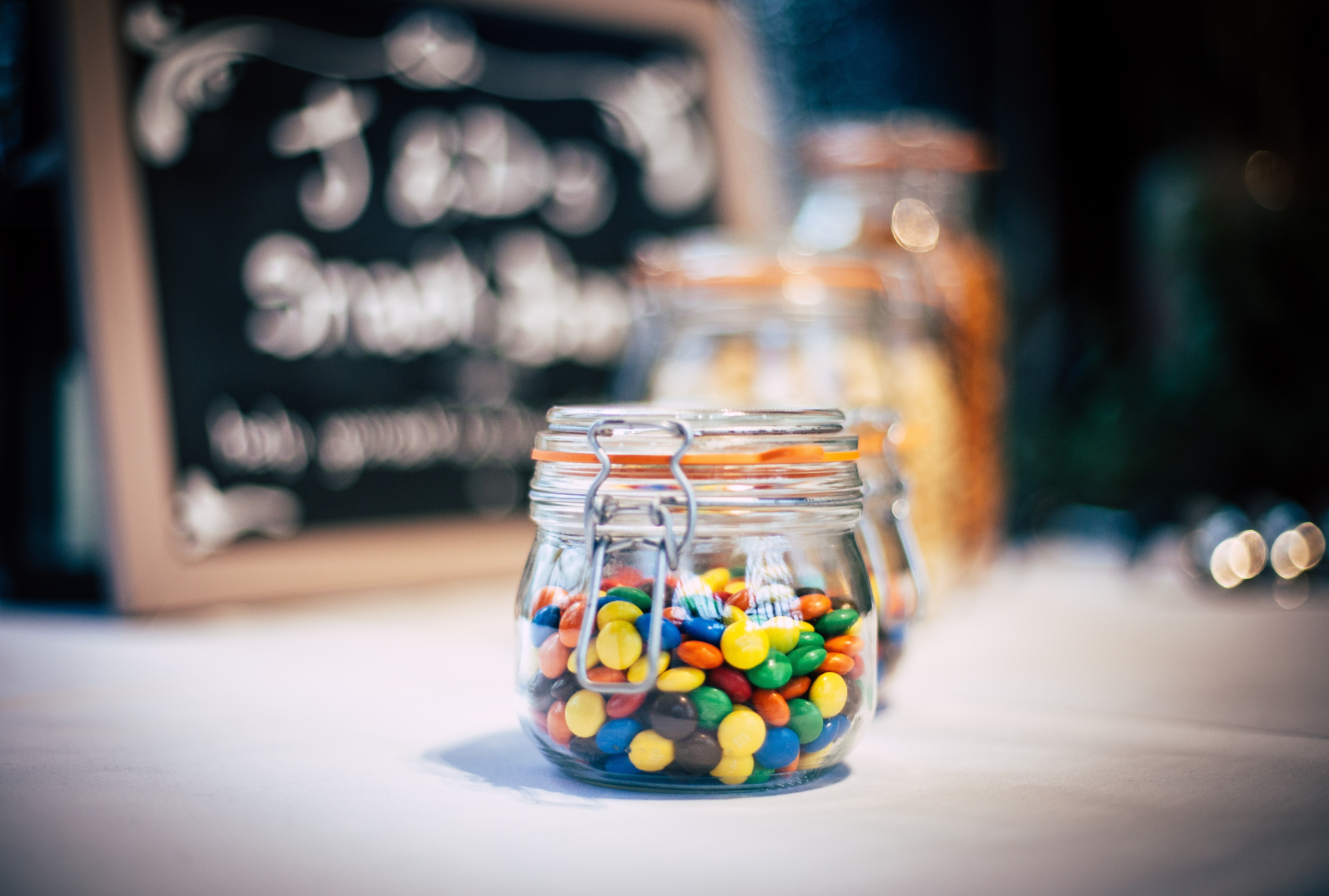 Glass jars filled with colorful candies HD Wallpaper