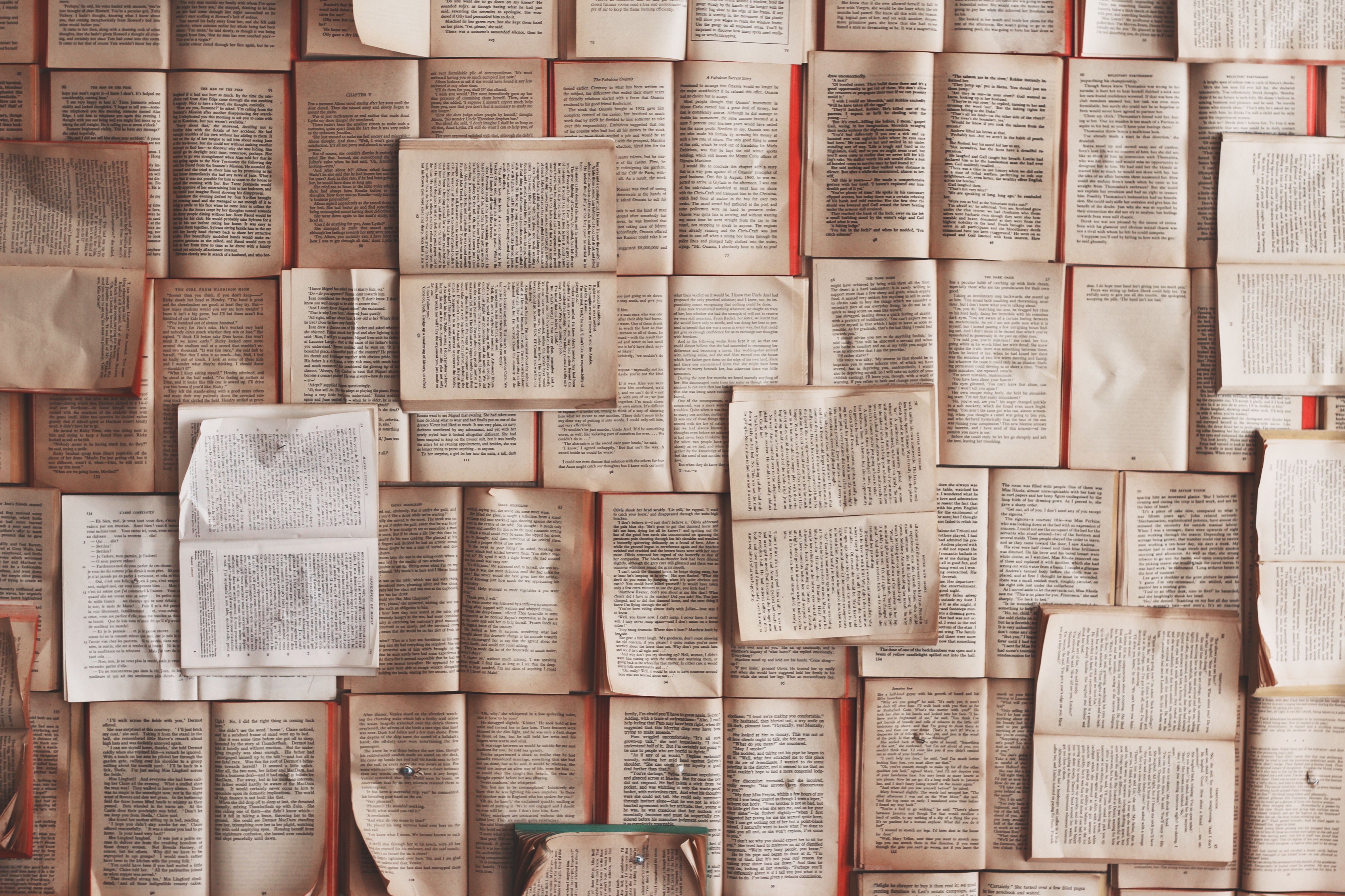 Wall of open books with text HD Wallpaper