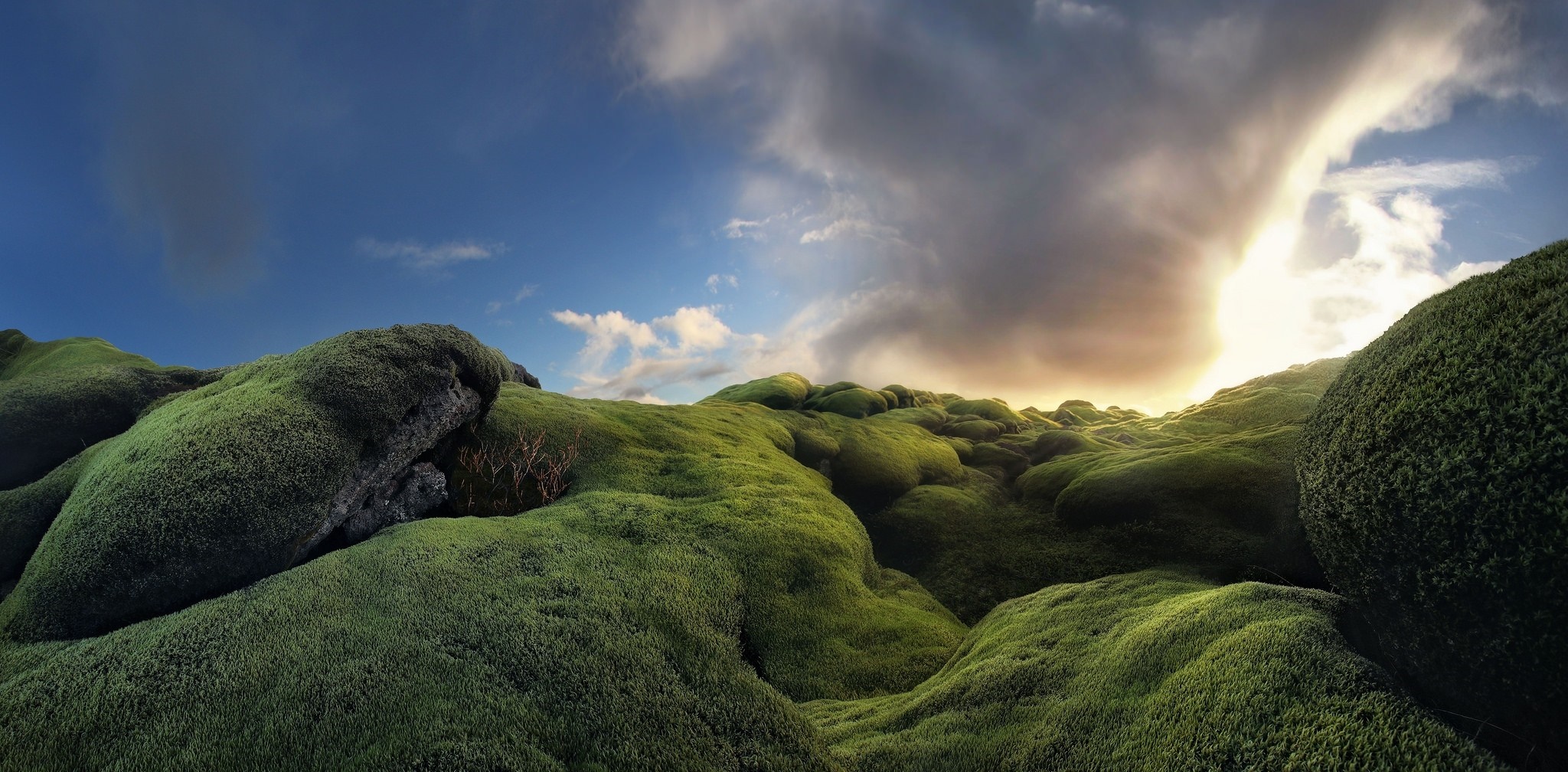 Mossy hills under dramatic sky in Iceland HD Wallpaper