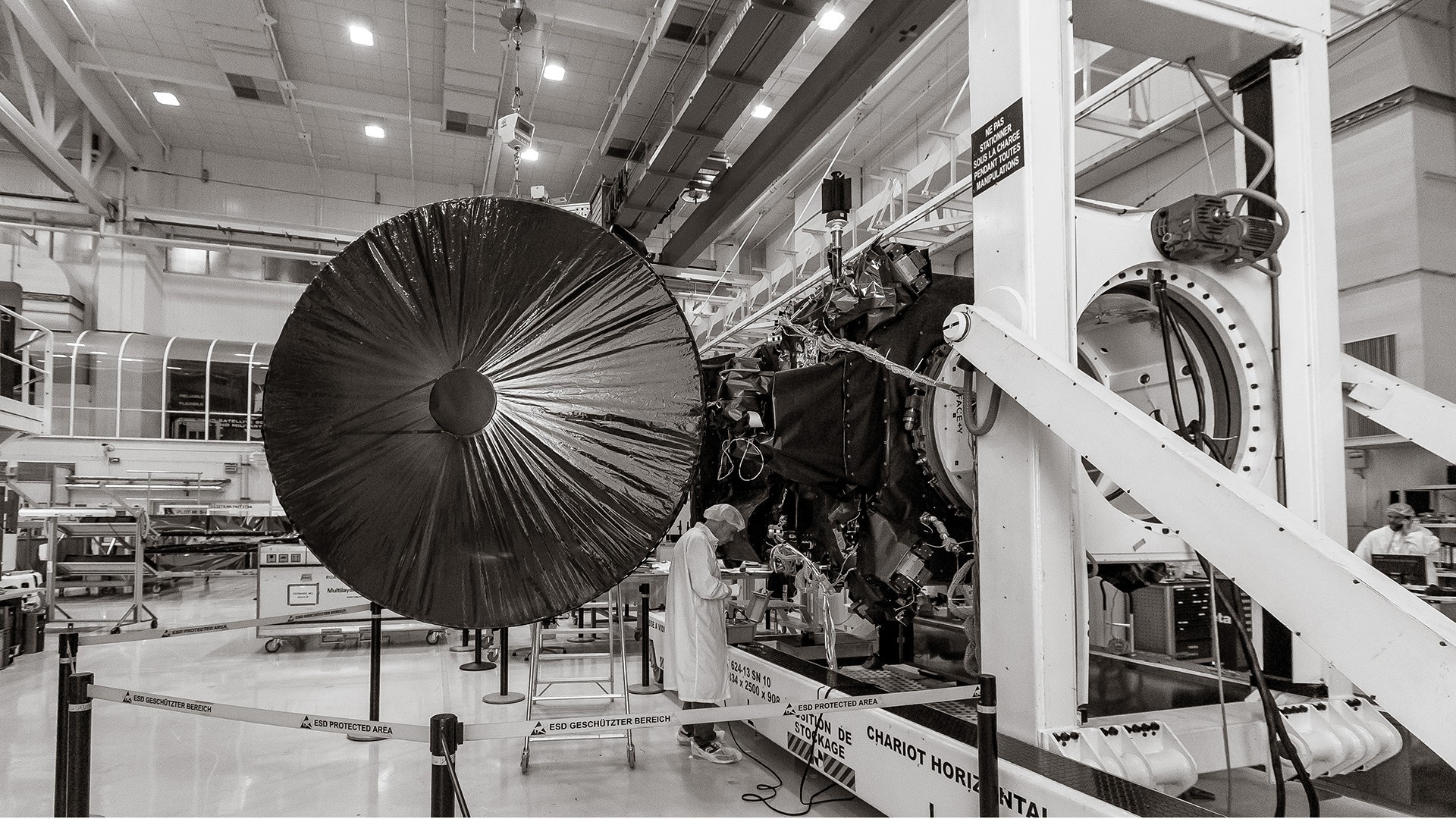 Spacecraft assembly in a cleanroom with large dish antenna HD Wallpaper