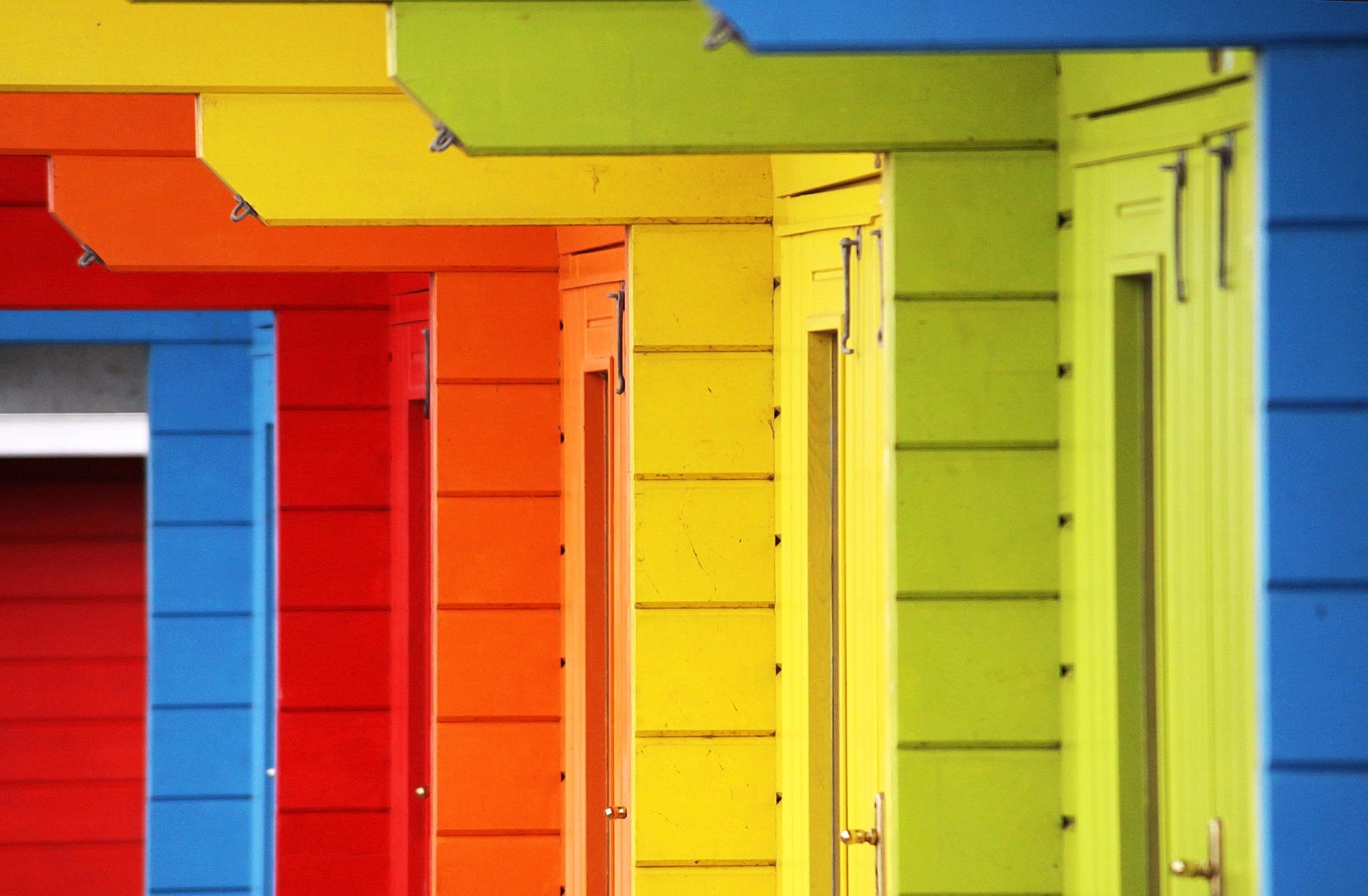Colorful wooden beach huts in a row HD Wallpaper