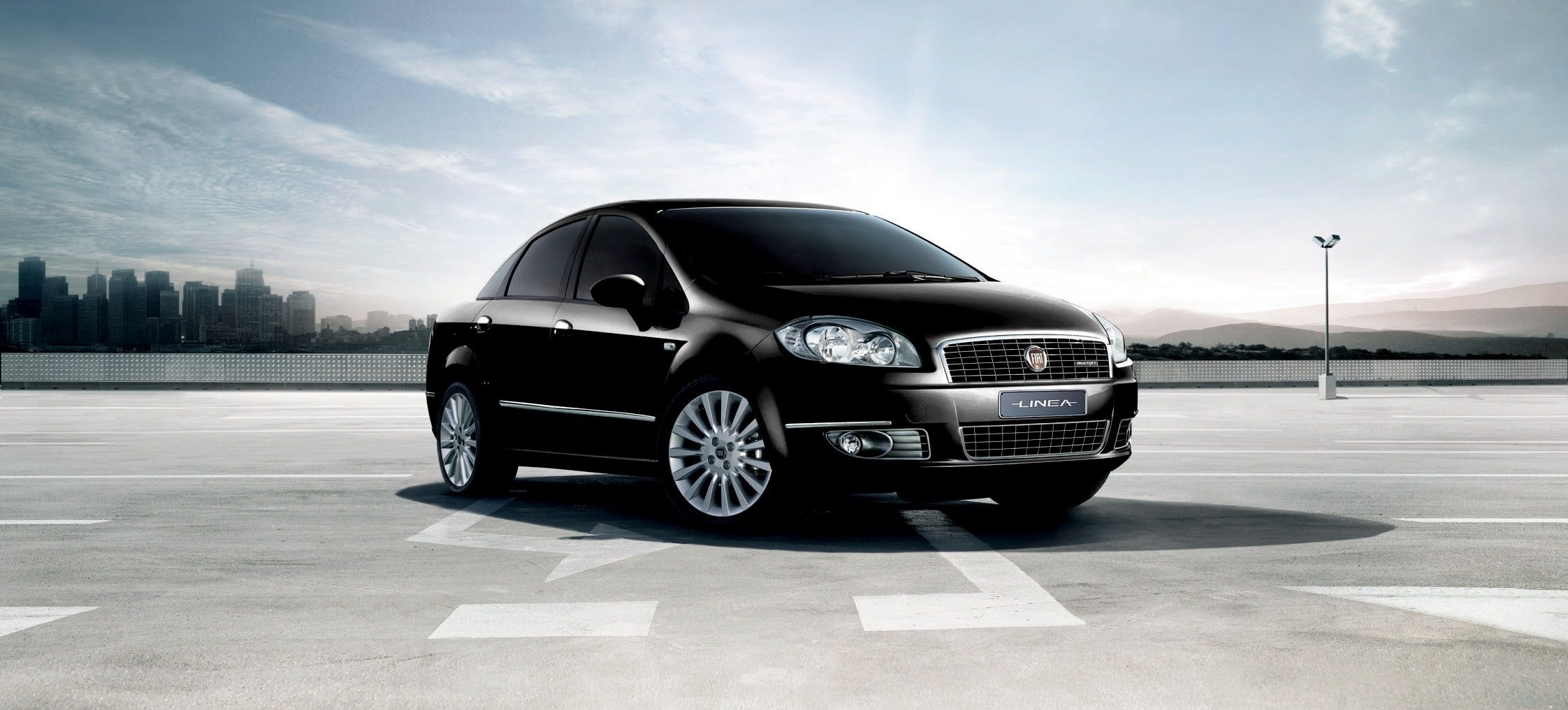 Black Fiat Linea Sedan parked in a city lot HD Wallpaper