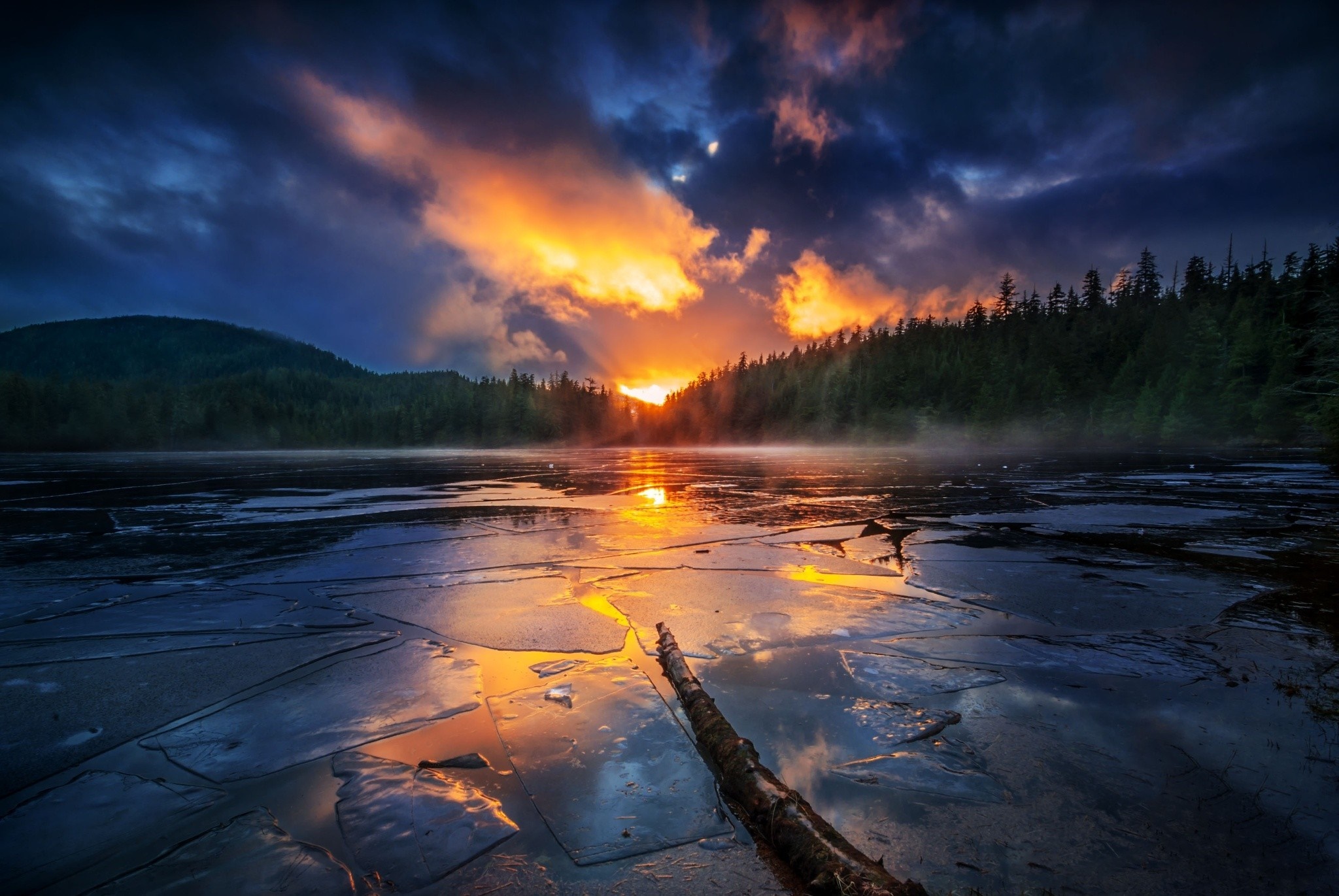 Sunrise over a frozen lake with forest and mountains HD Wallpaper
