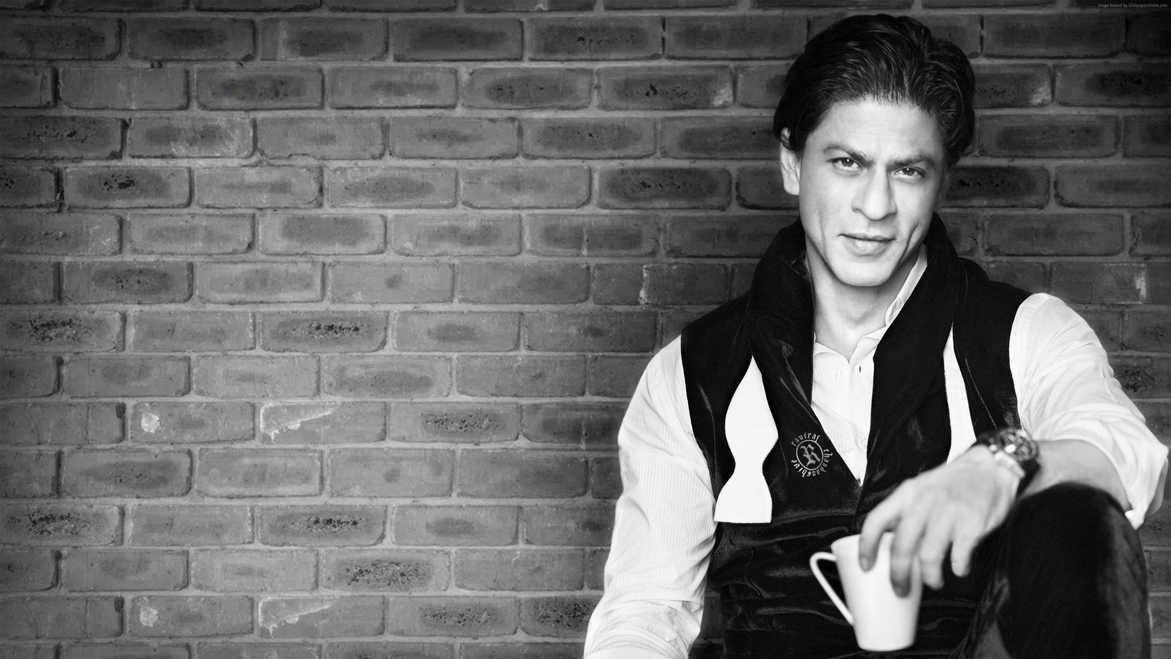 Shahrukh Khan sitting with a mug HD Wallpaper