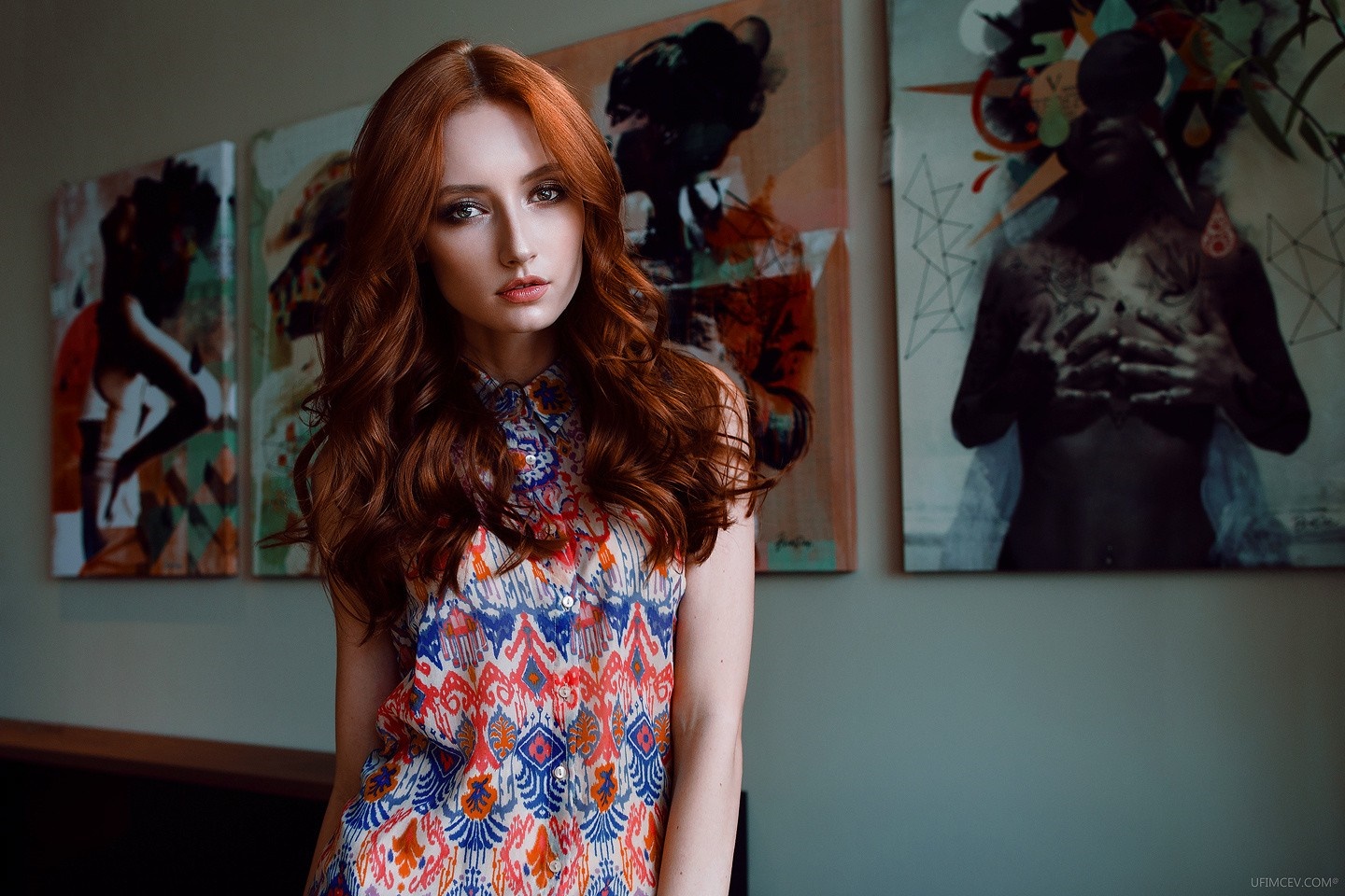 Redhead woman in colorful dress posing in front of art HD Wallpaper