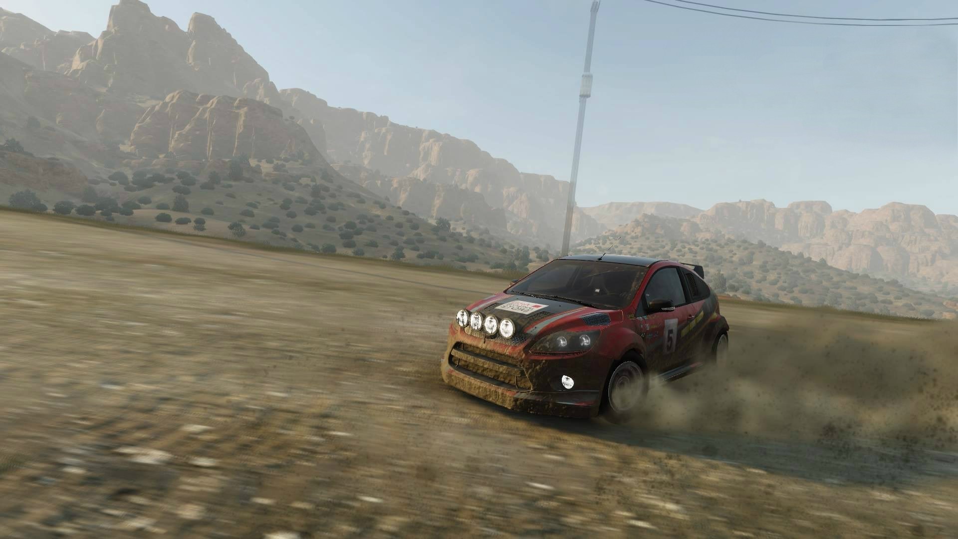 Ford Focus rally car driving on a dirt road HD Wallpaper