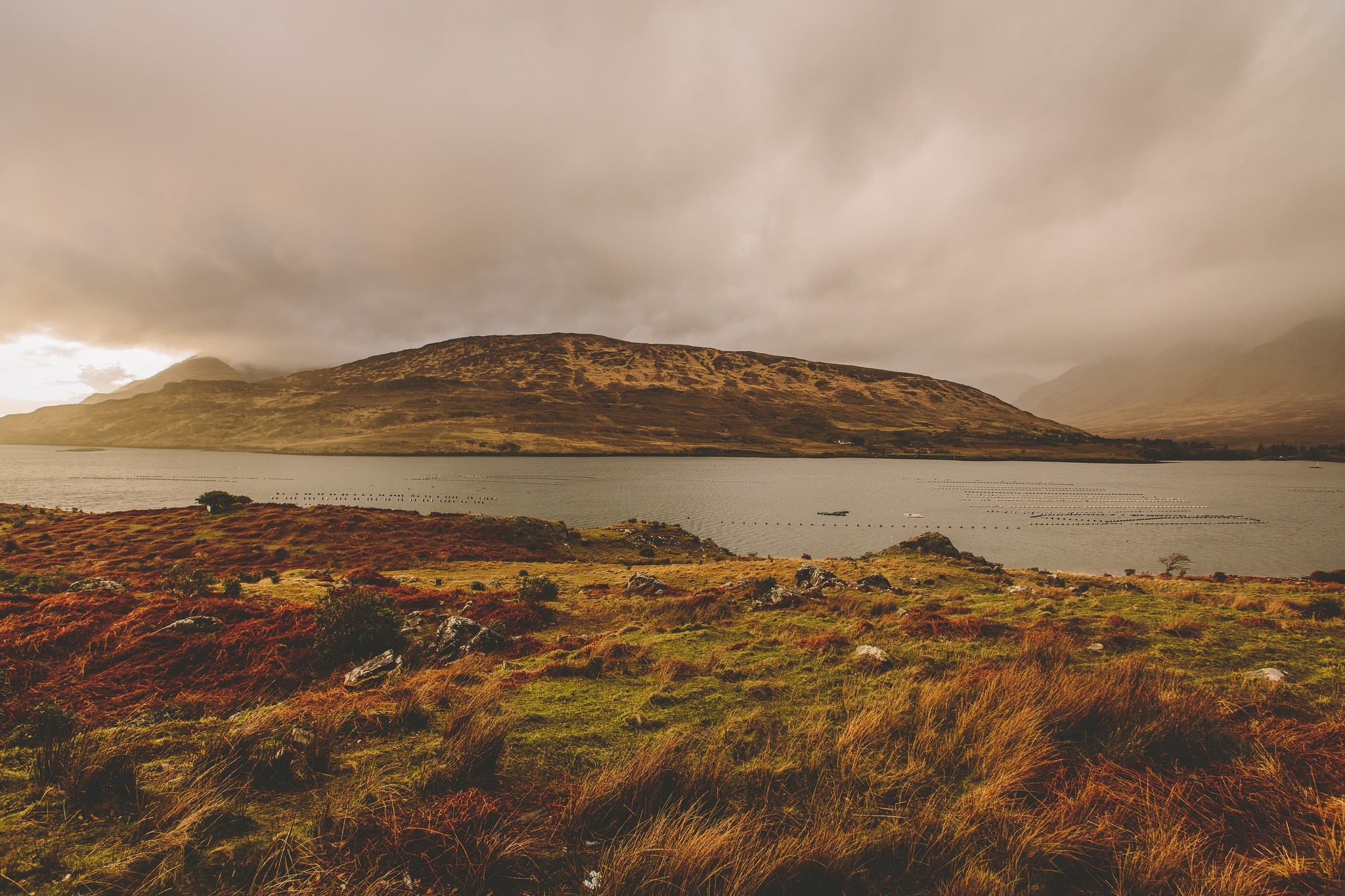 Autumn landscape with a lake and hills under cloudy sky HD Wallpaper
