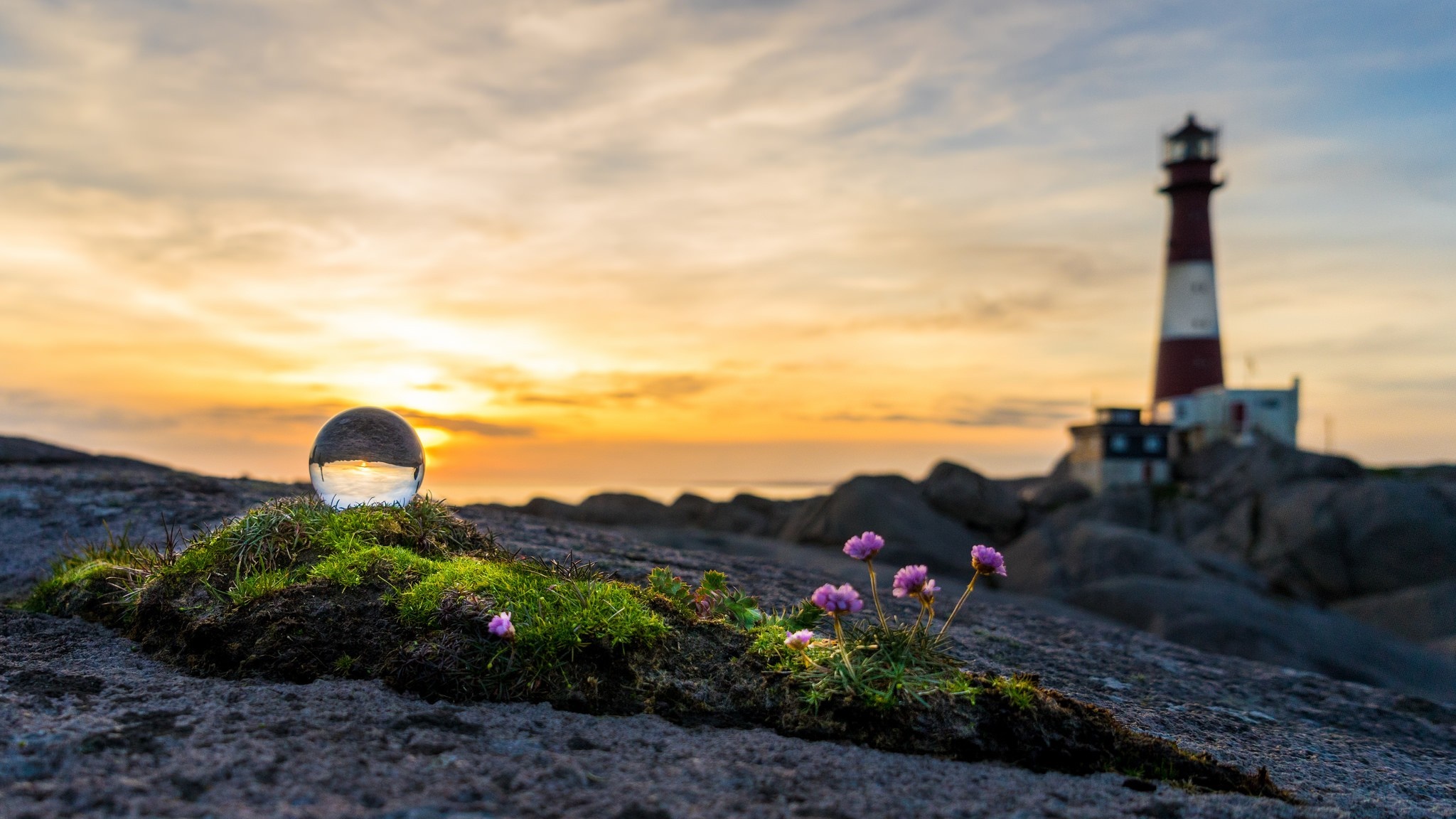 Crystal ball reflecting lighthouse at sunset HD Wallpaper