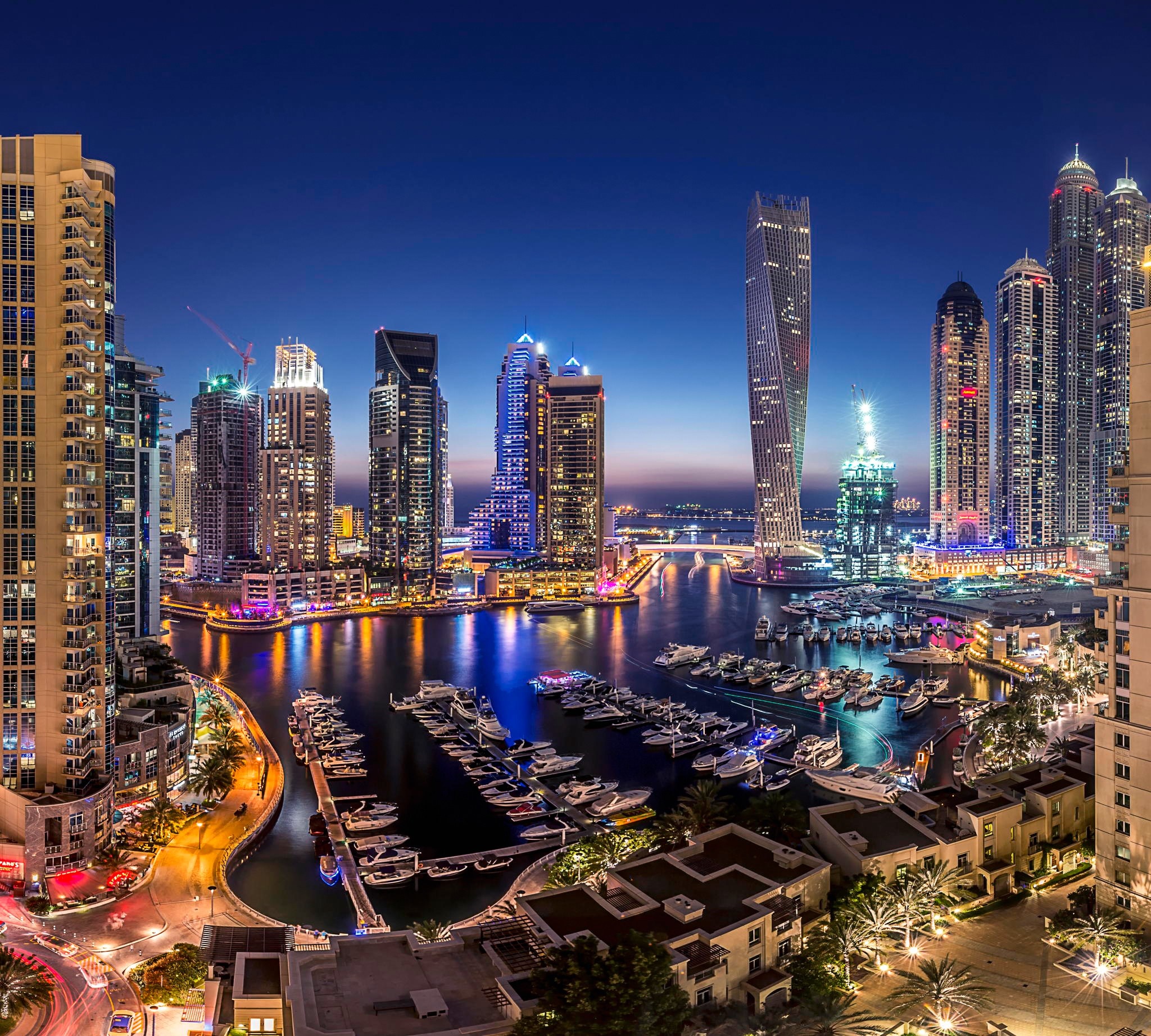 Dubai Marina cityscape at night with skyscrapers and yachts HD Wallpaper