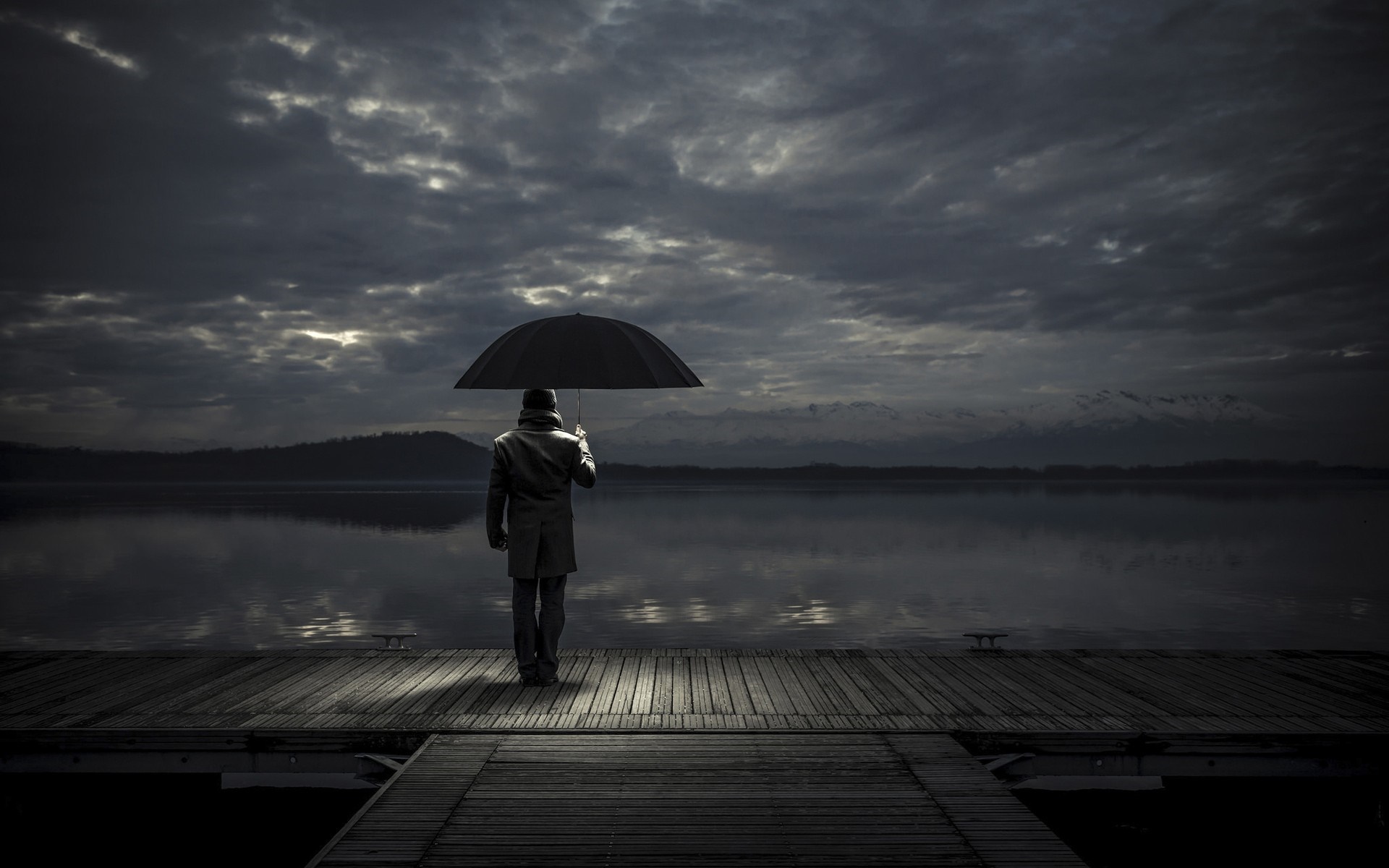 Man with umbrella on a pier at dusk HD Wallpaper