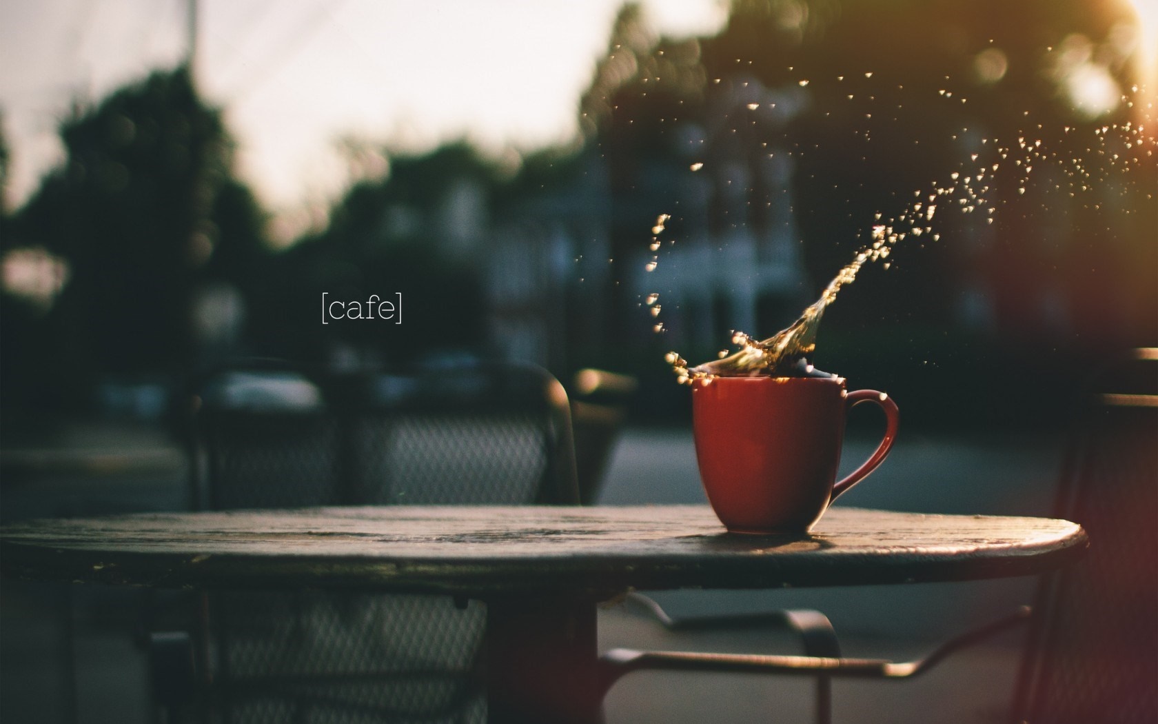 Red mug with coffee splash on a table HD Wallpaper